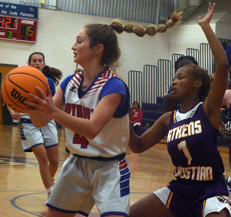 Elin Turner, who is in the eighth grade, keeps the ball away from an Athens Christian School defender in a game on Dec. 2. (Photo/Ralph Maxwell)