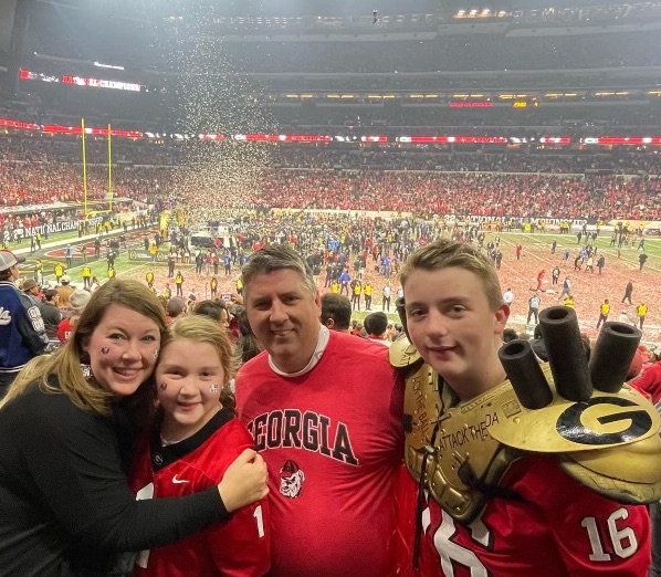 Katie (from left), Ellie Klaire, Kent and Jake Huff soak in the postgame atmosphere. (Submitted Photo)