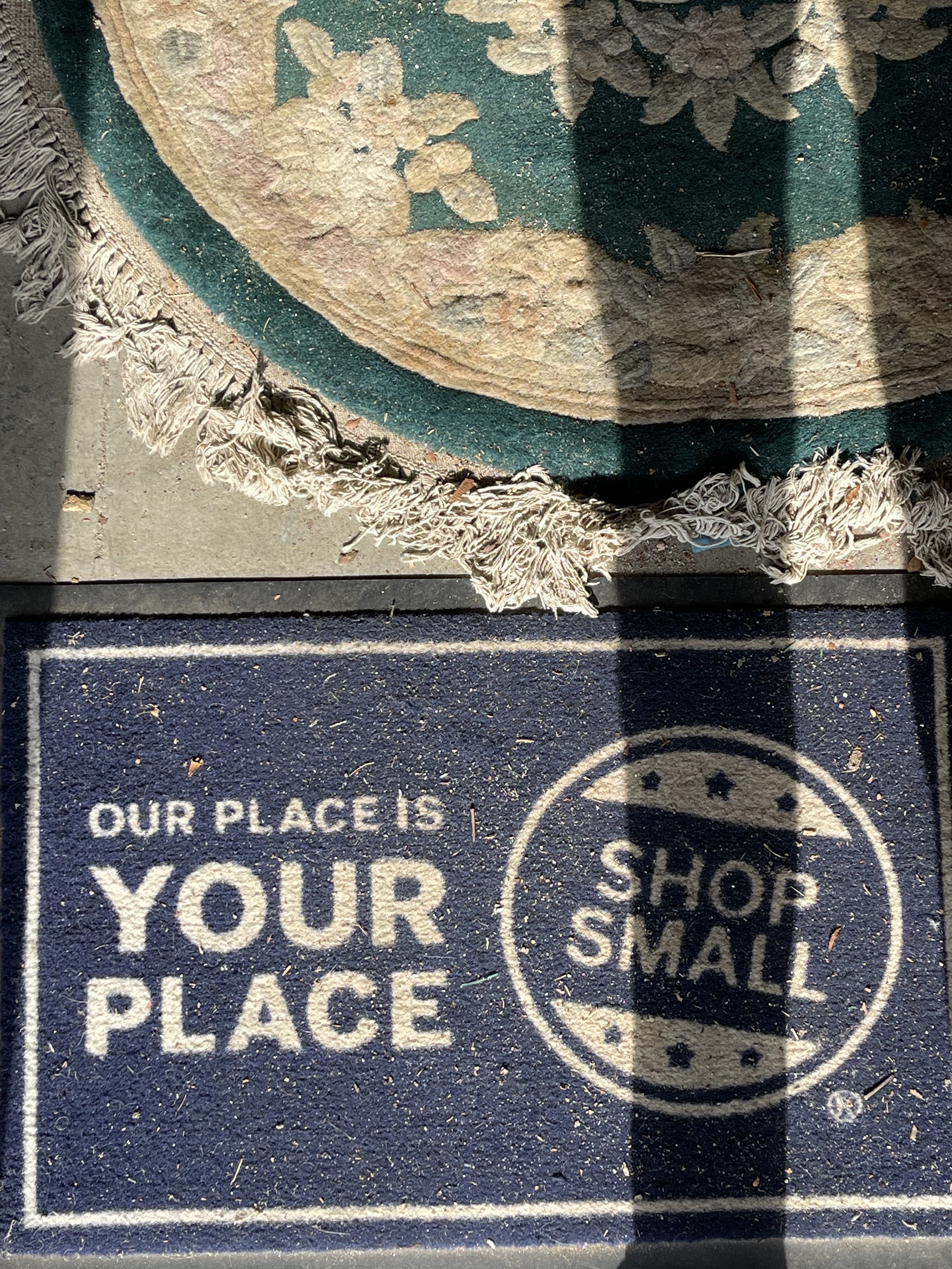 Visitors to Lexington Antique Mall are greeted by this welcome mat. Its mission is to remind customers to shop from local and small businesses. (Colt Yeargin/Oglethorpe Echo)