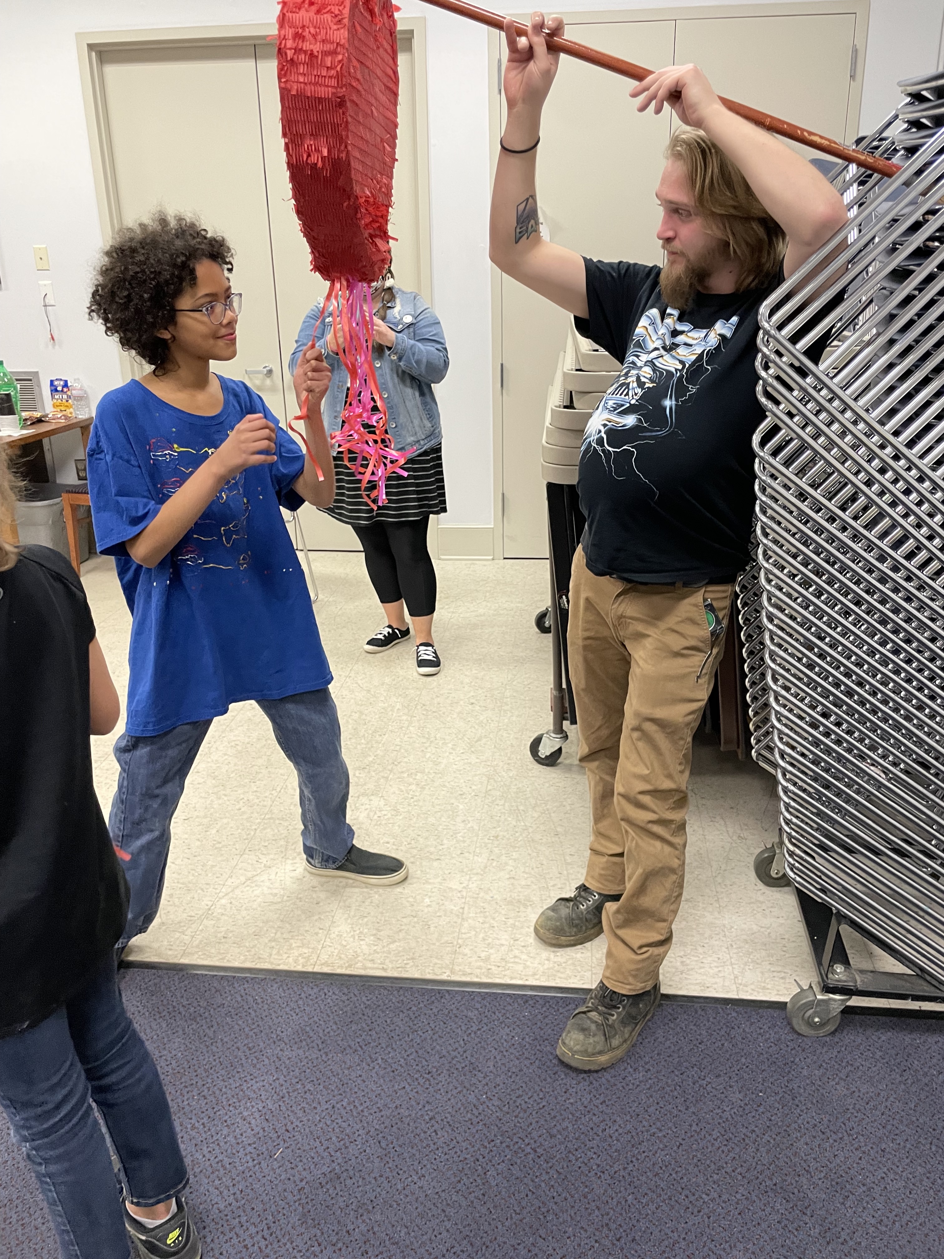 Sidney Wightman holds a  pinata for Marty Barclay at the  Oglethorpe County Library’s  Teen Anti-Valentine’s Day event. (Yana Obiekwe/Oglethorpe Echo)