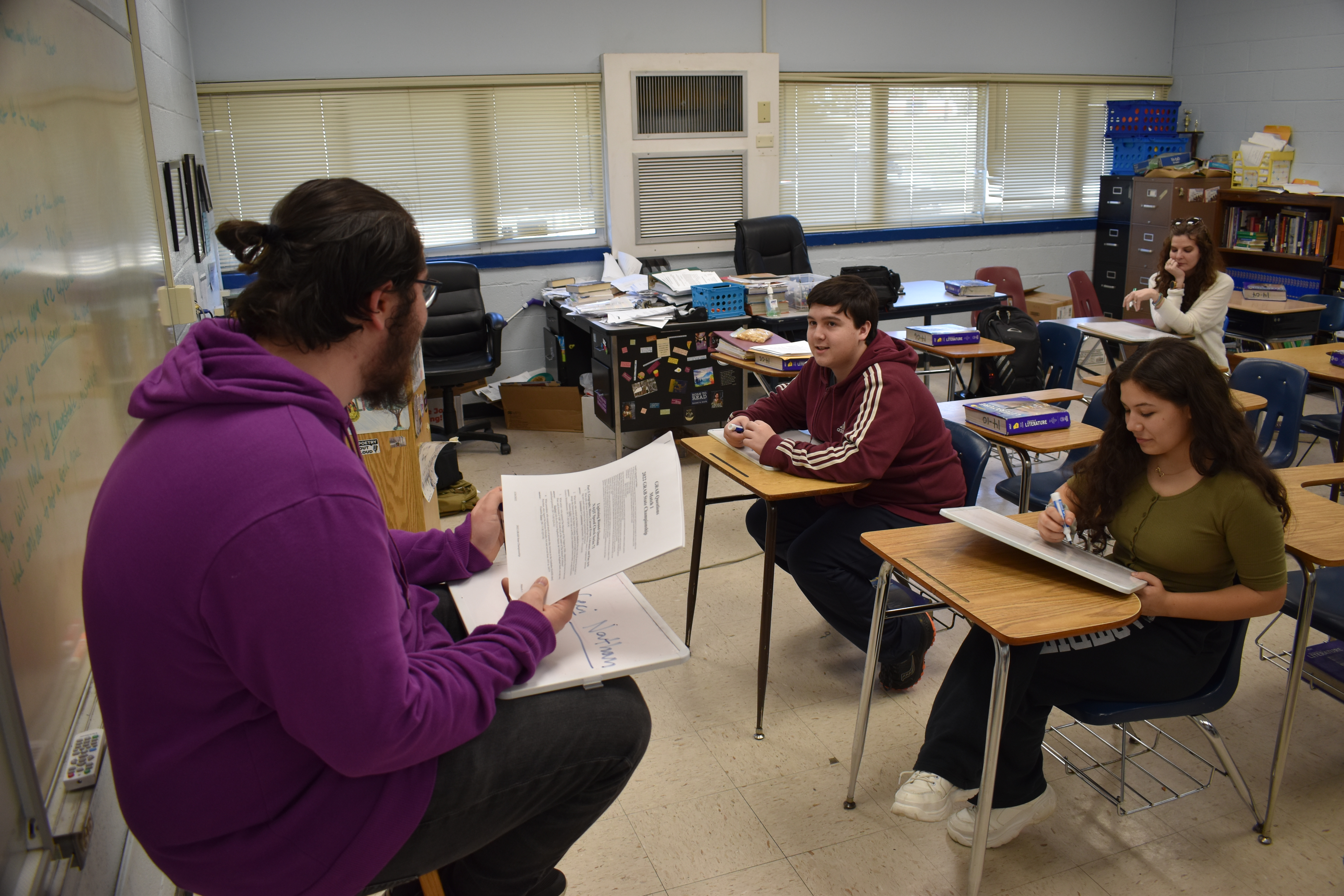 Bo Doker reads a question for Nathan Wilson and Cecilia Negrete. The OCHS academic bowl season just ended, but the team is already preparing for next year. (Thomas Ehlers/The Oglethorpe Echo)