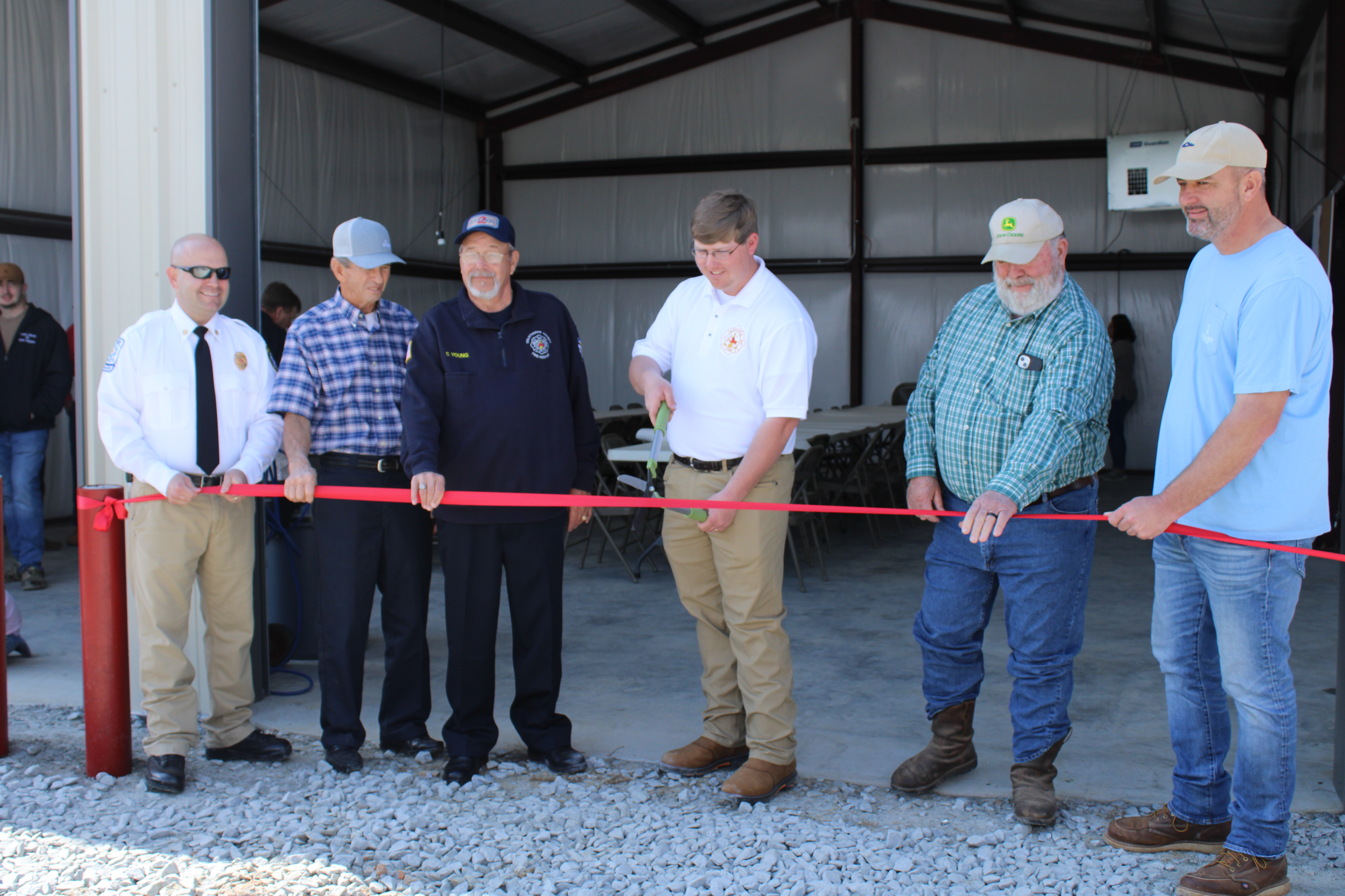 The Salem Fire Department celebrated the opening of its new station on March 5. Justin Sanders (from left), Lee Thaxton, Adam Nation, Carl Young, Phil Sanders and Ethan Thaxton line up for a photo before cutting the ribbon. (Eloise McNair/The Oglethorpe Echo)