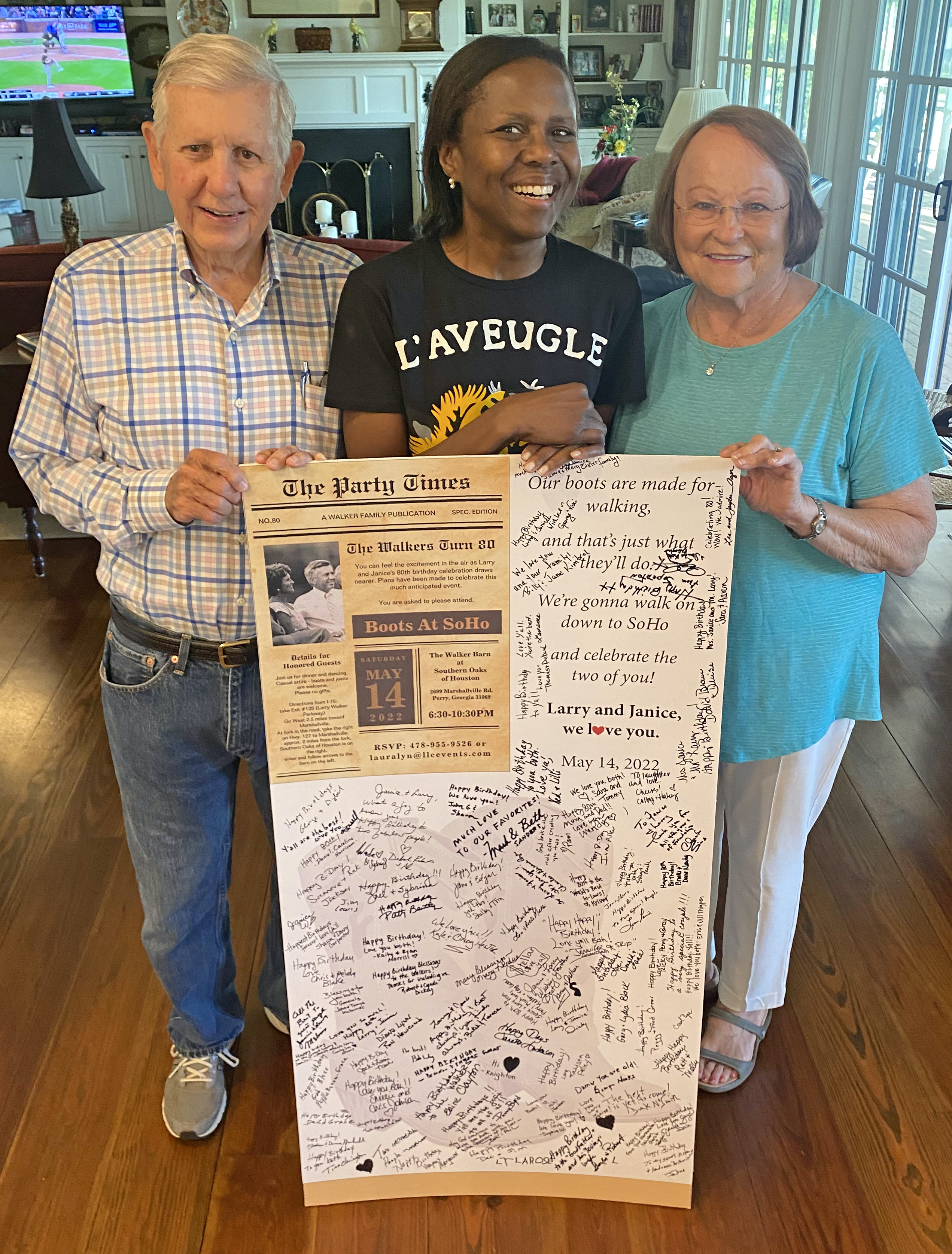 More than 260 people flew or drove to Perry to help celebrate Larry and Janice Walker’s 80th birthdays. One of Larry Walker’s biggest fans is Perry’s Deborah Roberts, a UGA grad and journalist for ABC News, who traveled from New York City. Roberts stands between the Walkers, holding a commemorative birthday poster. (Photo/Dink NeSmith)