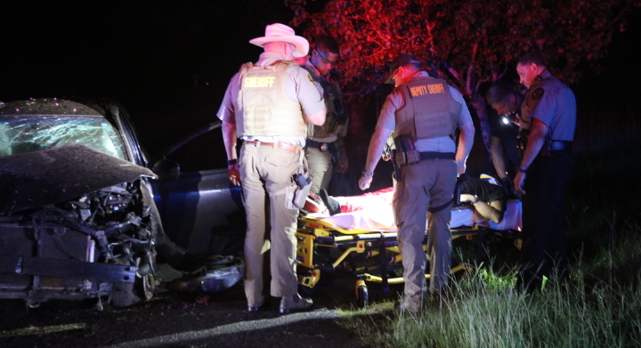 Law enforcement officers surround Taran Allen, who was taken to a local hospital after a high-speed chase ended with him crashing in a Lexington yard. (Photo/Tom Thon)