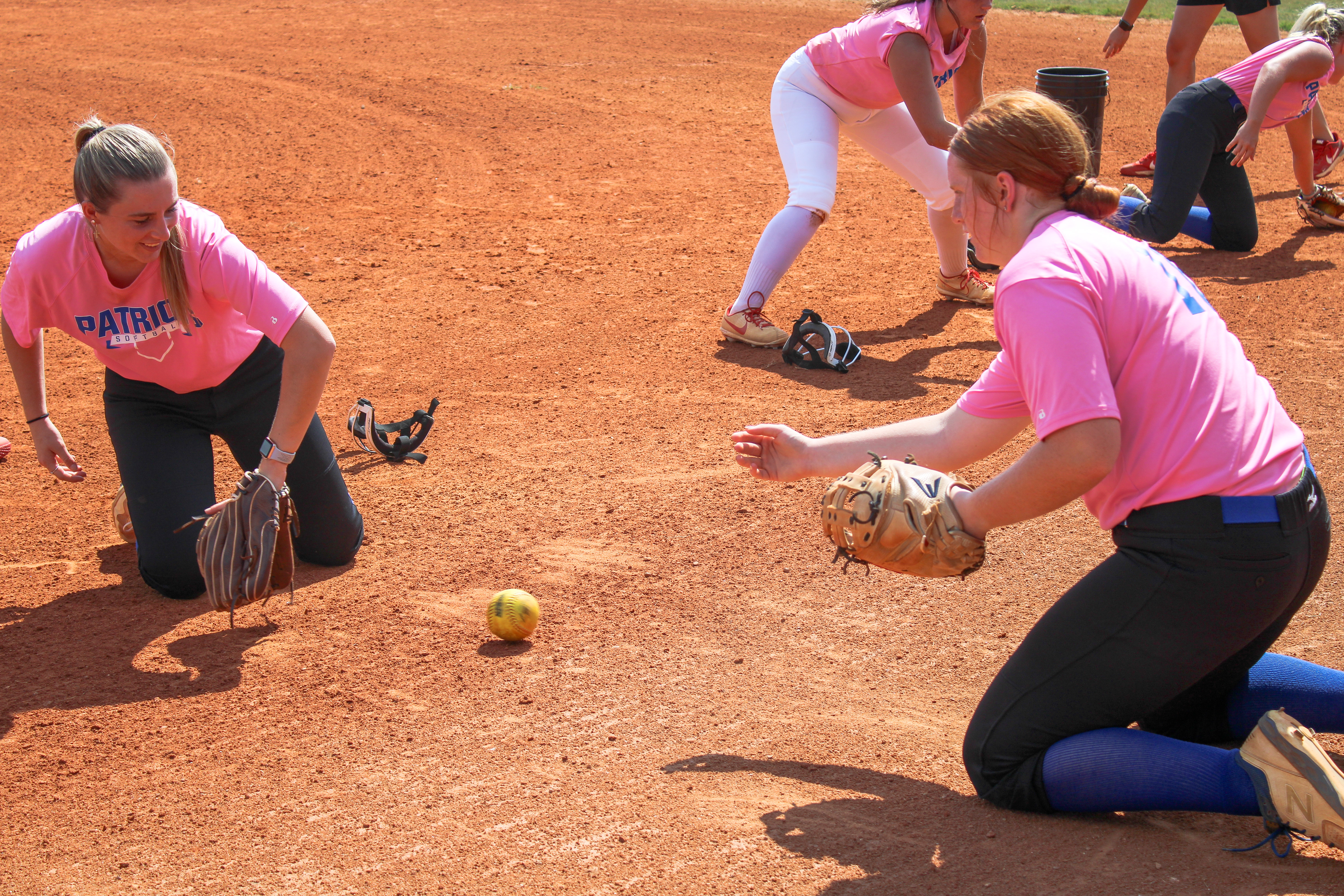 (De Turner/The Oglethorpe Echo) Senior Claire Gabriel, left, and junior Abby Jones work on a fielding drill together during practice. The pitcher and catcher have played together for several years.