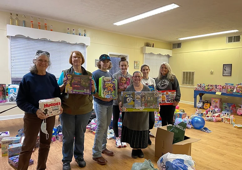 Community Christmas of Oglethorpe County co-director Shirley Dillard and toy coordinators April Moore and Tina Welch-White stand with volunteers and donated toys. (Submitted Photo)