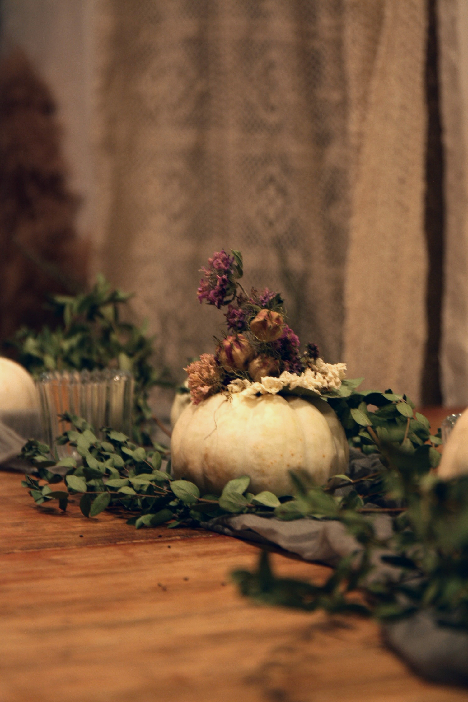 Floral artist Jenny Derevere adds both homegrown and foraged dried Nigella, Monarda, snapdragon and Scabiosa, or pincushion flower, to a white pumpkin for a twist on natural fall decor. She uses blossom from her flower farm in Stephens. (Photo/Isabelle Manders)
