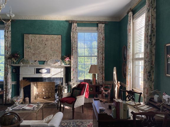 Boldly patterned, floor to ceiling curtains in one of Linda Parish’s front rooms serve as a focal point. (Photo/Erin Kenney)