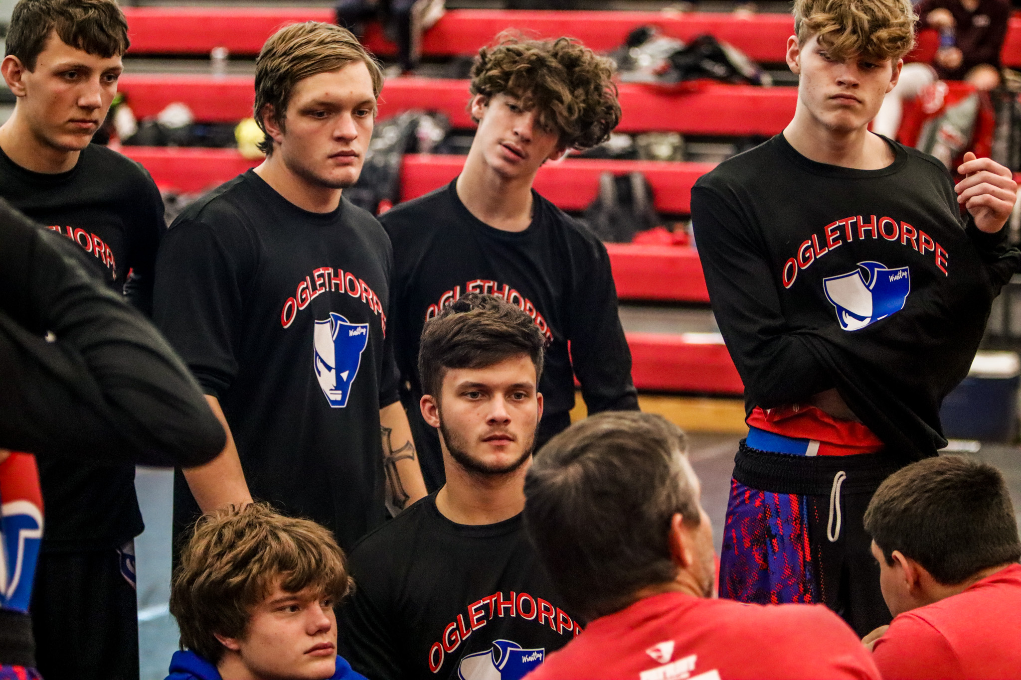 The Oglethorpe County wrestling team listens to instructions from coach Tim Stoudenmire  in preparation for its matches at the North Oconee Duals at North Oconee High School on  Saturday