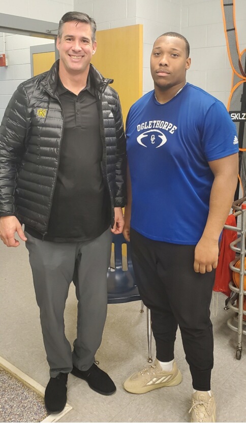 SUBMITTED PHOTO Kennesaw State inside linebackers coach Greg Harris recently visited with OCHS football player KB Bonds and other athletes. 