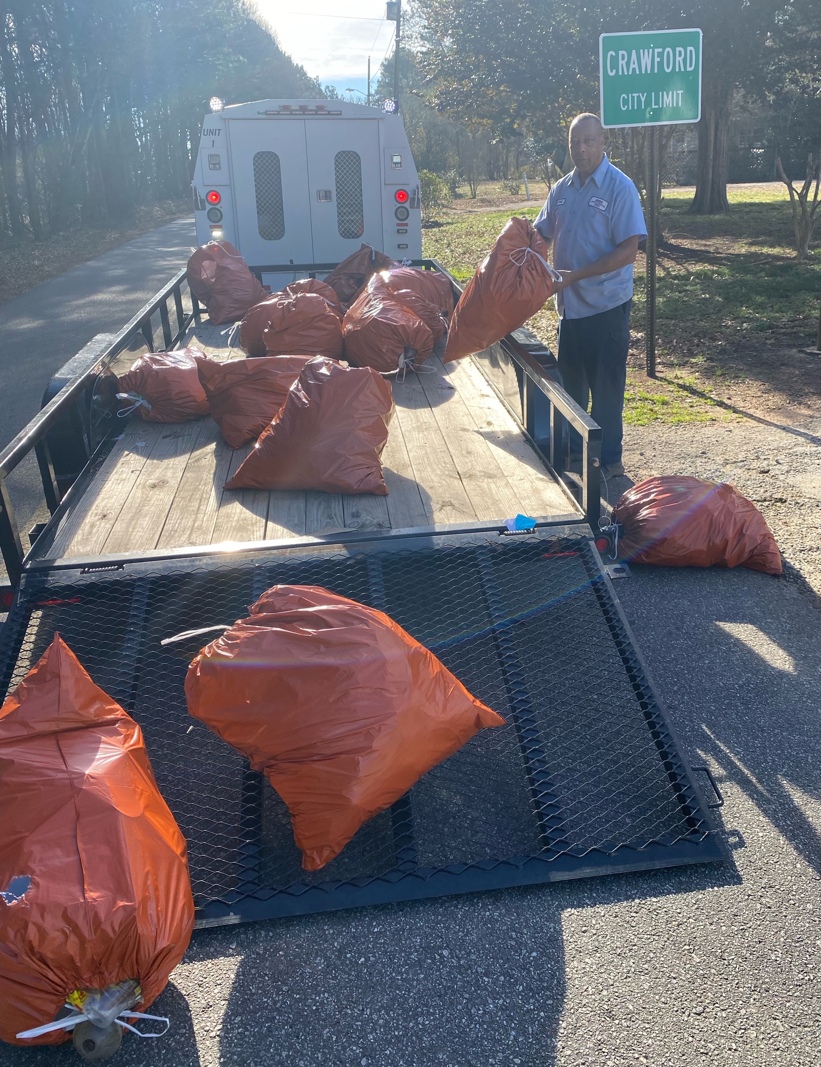 Twice each month, first-time DUI offenders are court-ordered to provide community service by picking up litter along Oglethorpe County’s streets and roads. On Jan. 28, six offenders gathered 180 pounds of debris along a half-mile stretch of Woodlawn Street in Crawford. Loading the orange bags is Will Eberhart, who supervises the detail for the Oglethorpe County Public Works Department. TAYLER EBERHART/FOR THE OGLETHORPE ECHO
