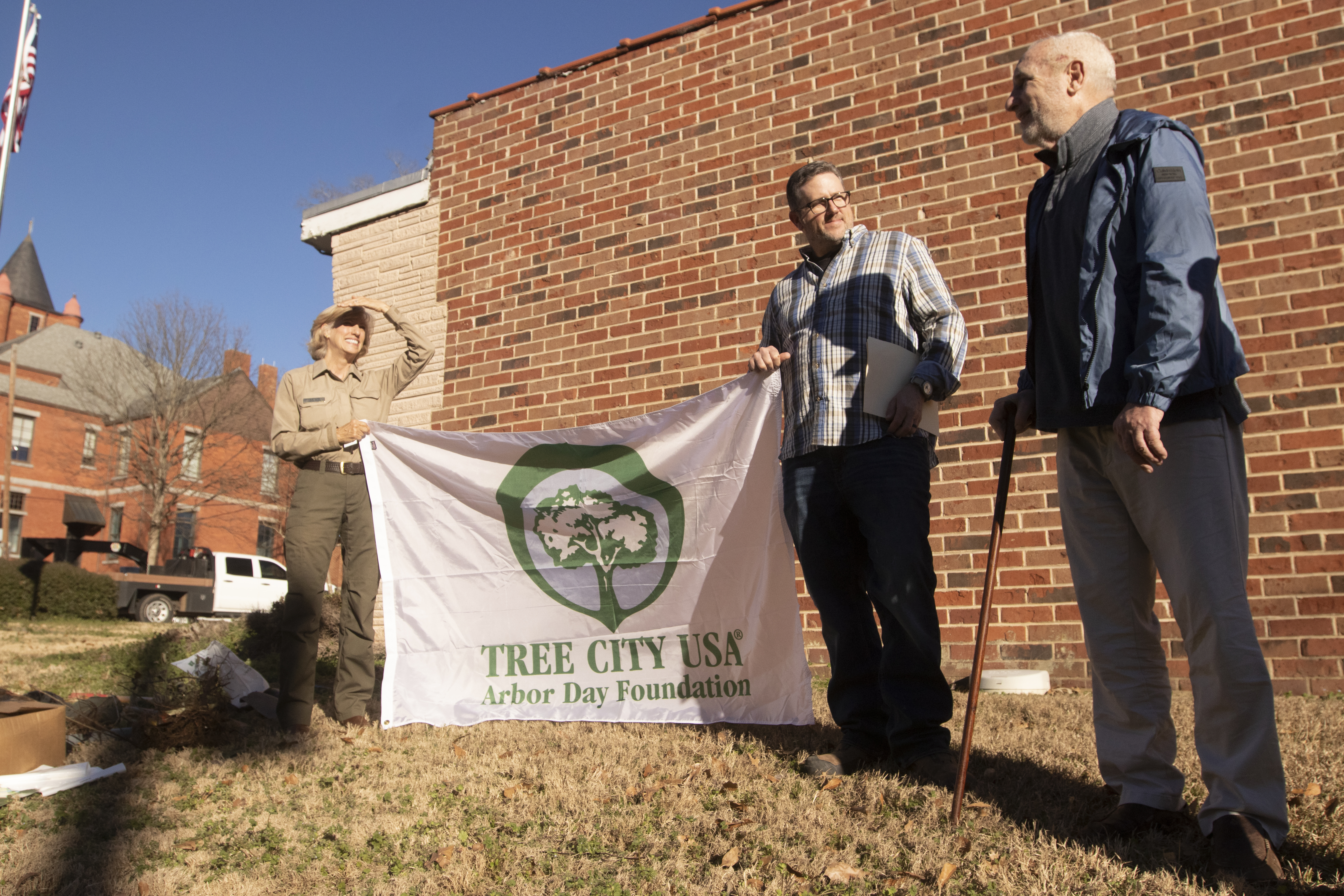Forester Lea Clark (from left), Lexington Mayor Craig Snow and Ralph Maxwell stand at the spot of the soon-to-be planted red oak by the Lexington Post Office on Saturday. The tree was planted to honor Maxwell, the former publisher of The Oglethorpe Echo. (SOPHIE MCLEOD/THE OGLETHORPE ECHO)