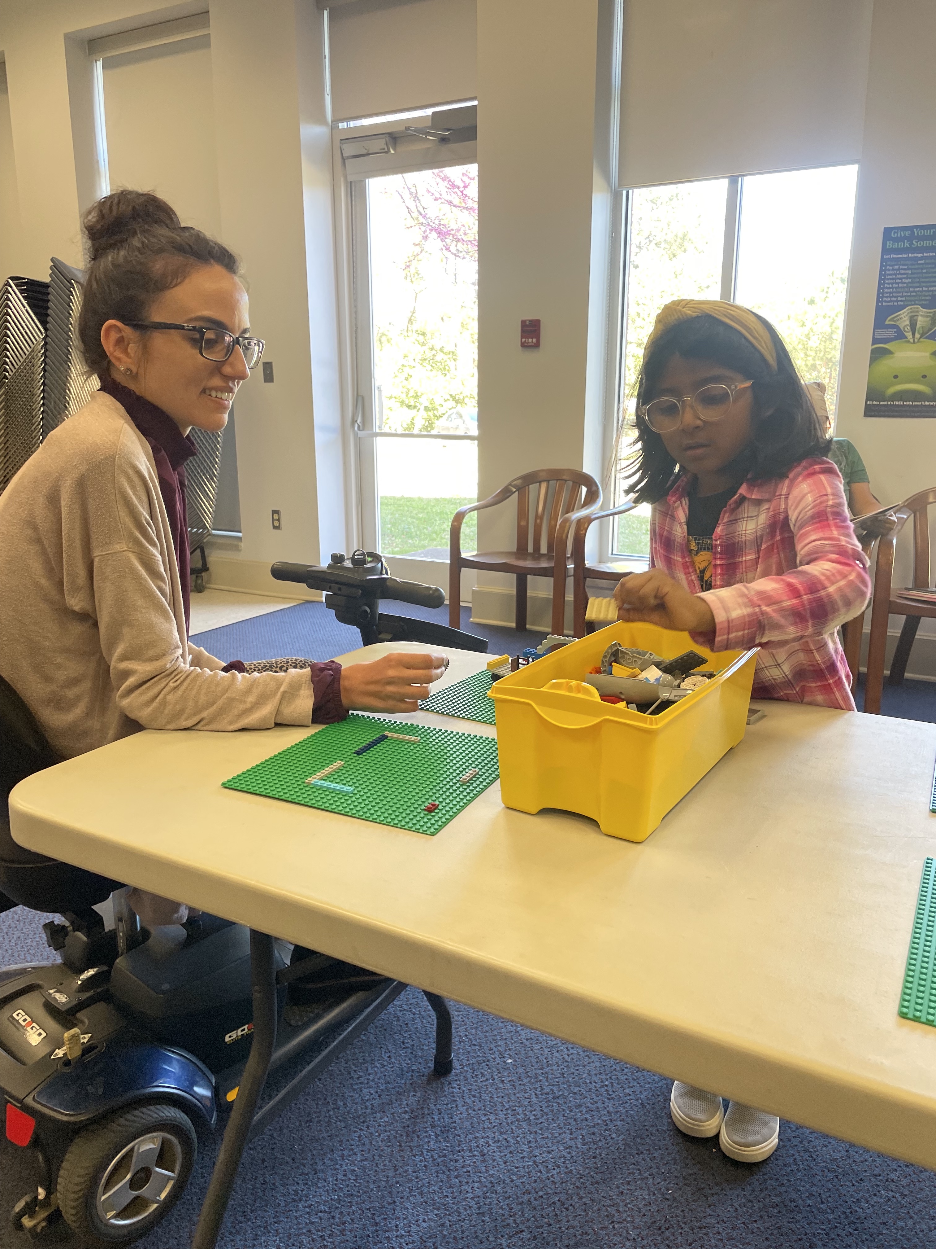 Jessica Ellis (left), who works at the Oglethorpe County Library, and Emma Hernandez (right) chat while Hernandez builds the beginning stages of a treehouse. The library hosts the Lego Club once a month. (RAMON ELORTONDO/THE OGLETHORPE ECHO)