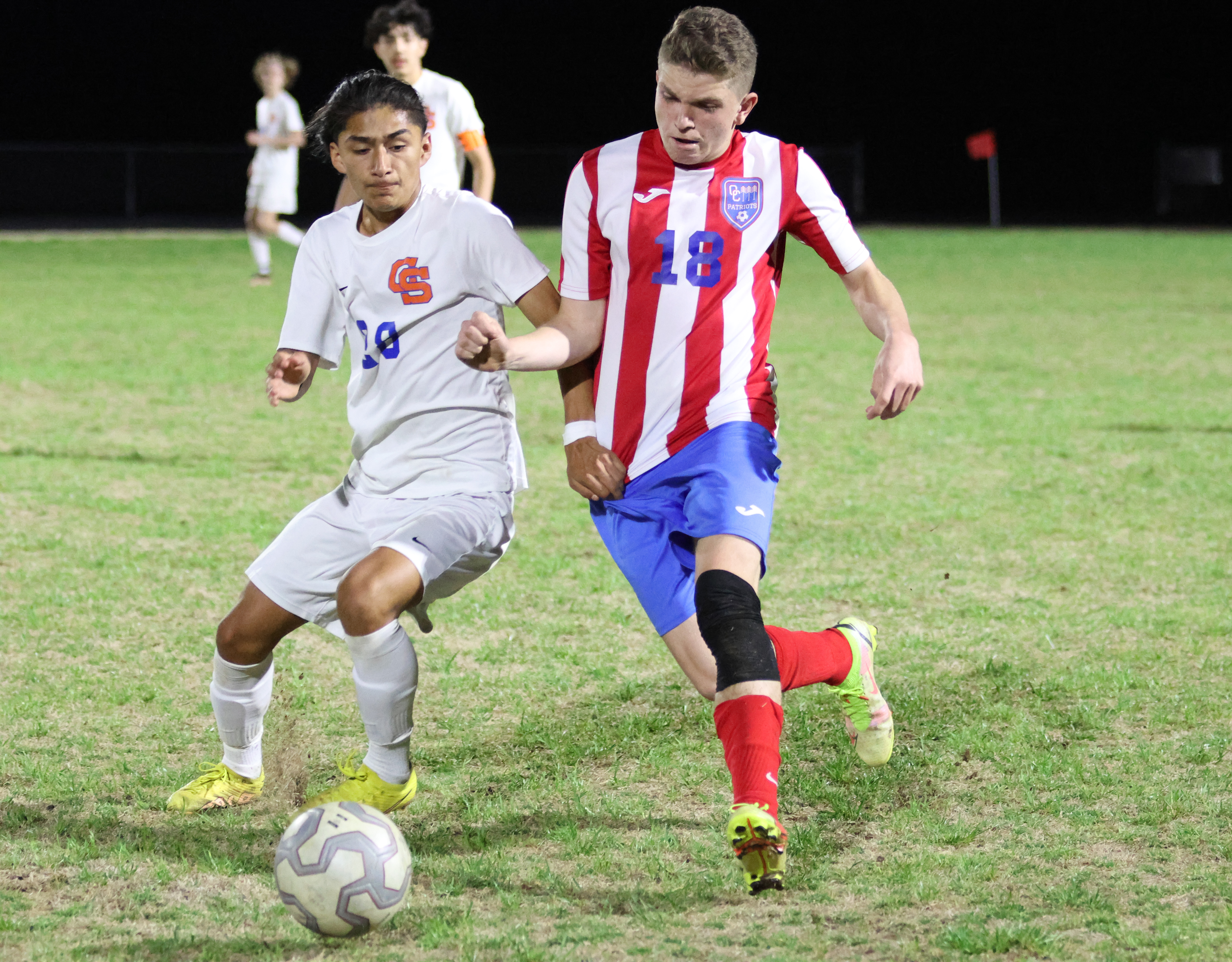 Oglethorpe County senior Soren Wisby (right) battles a Cedar Shoals player for possession during Oglethorpe County's 5-0 loss at Cedar Shoals last Tuesday. The Patriots will host Mount Vernon in the first round of the Class A Division I tournament on April 12. (Photo/Emily Dozier)