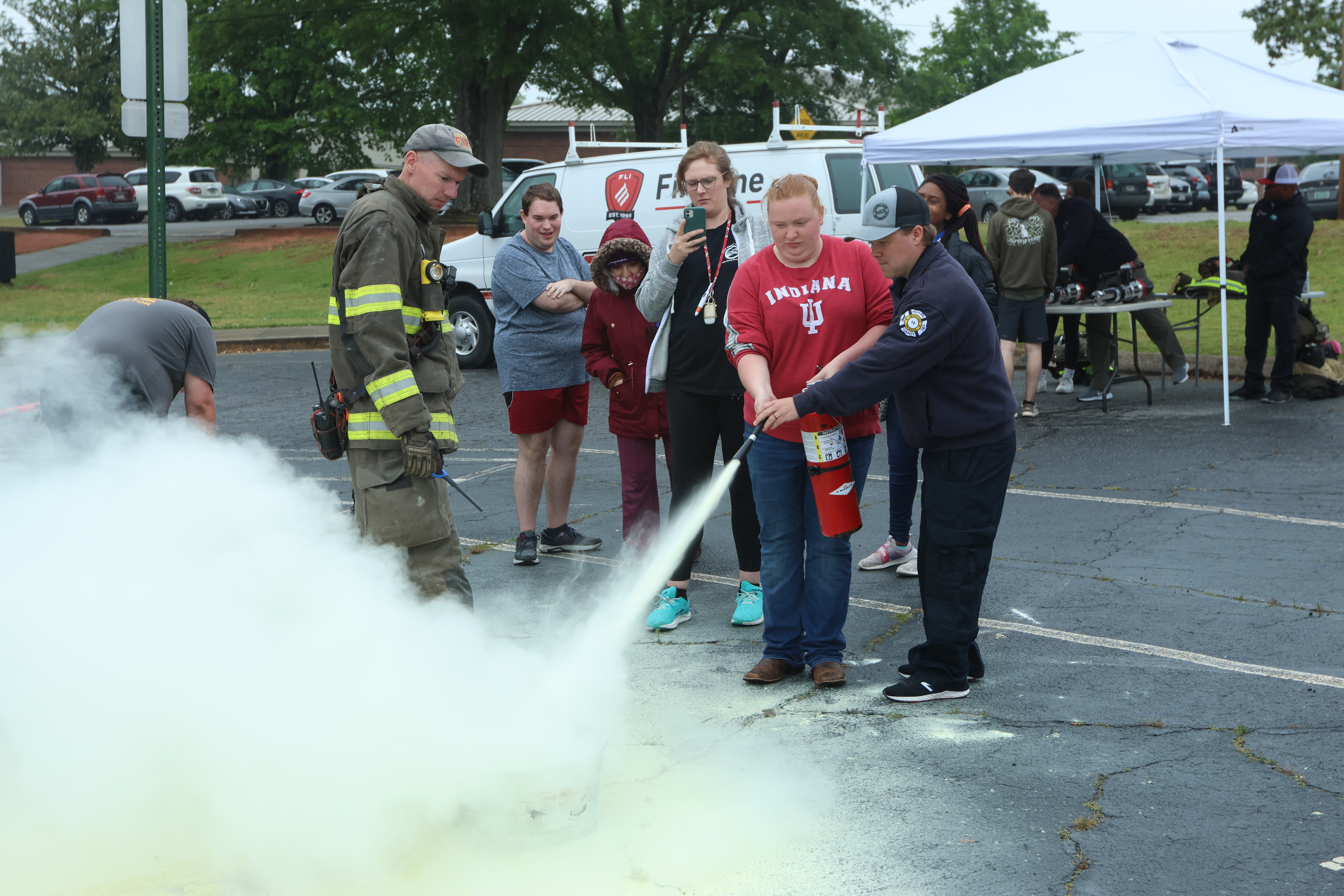 First responders Cody Gibbs (from left) and Matthew Echols help Oglethorpe County High School student Kayla Bass practice with a fire extinguisher. Gibbs recently won AEMT of the Year at the Region 10 EMS Banquet. (LANDEN TODD/THE OGLETHORPE ECHO)