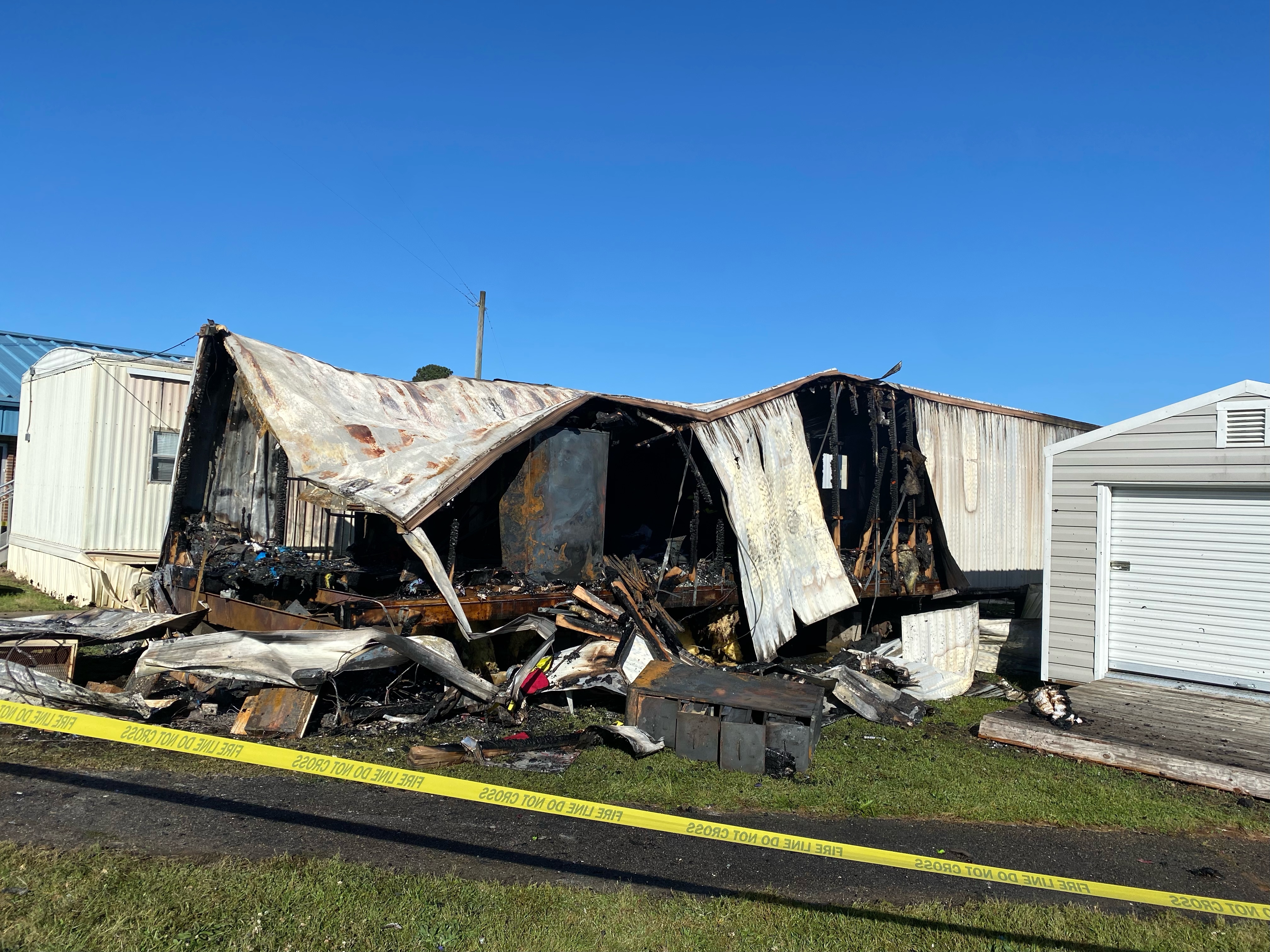 Caution tape surrounds the remains of a storage trailer that burned at Oglethorpe County Elementary School on Monday morning. The trailer contained paper and decorations for themed celebrations. (DINK NESMITH/THE OGLETHORPE ECHO) 
