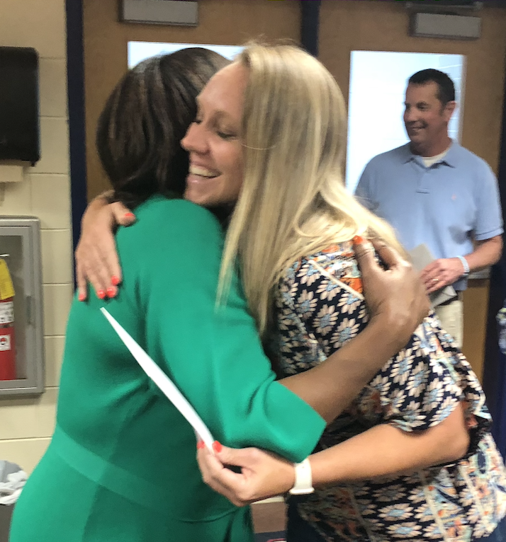 Lauren Carlson, who will be the new assistant principal, hugs Susie Johnson on Tuesday. (ANDY JOHNSTON/THE OGLETHORPE ECHO)