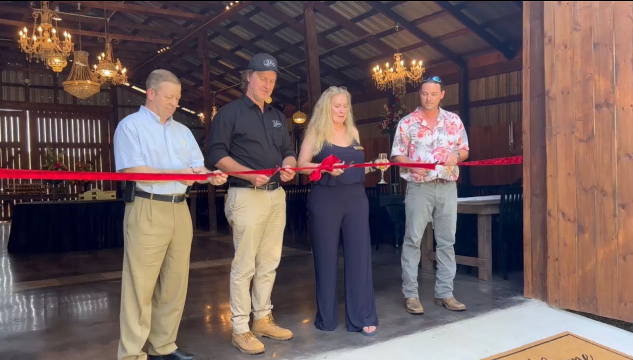 Oglethorpe County Commissioner Tracy Norman (from left), owners Blake and Shannon Bailey, and Crawford Mayor Seavy O’Neal prepare to officially open The Grove at Bailey Farms last Saturday. The new venue is on the site of the former Nix farm, which was owned by Aubrey Nix, who died in 1989. (SUBMITTED PHOTO)