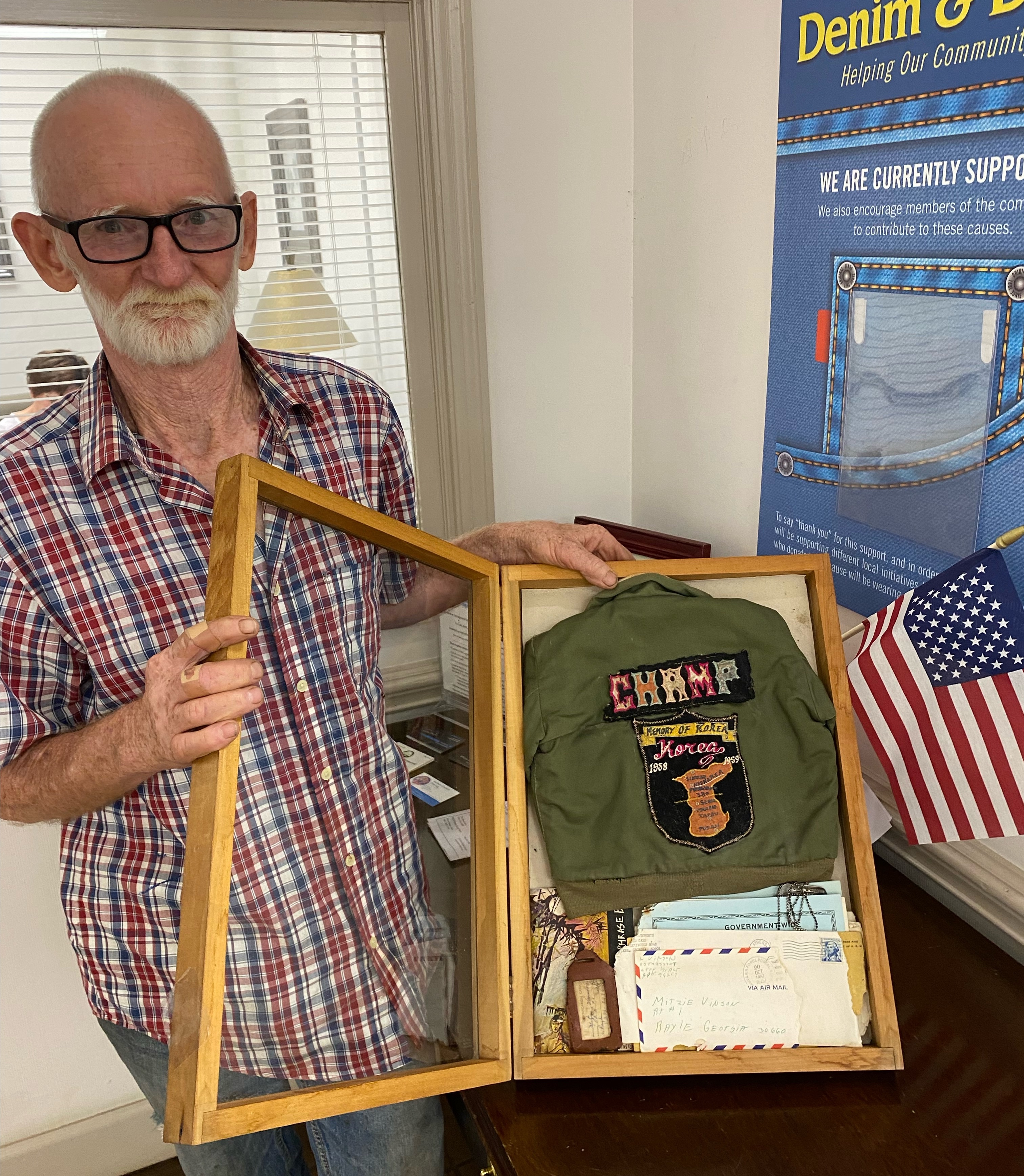 James Bennett, who owns Lost & Found Antiques and Collectibles in Lexington, filled a shadowbox with the custom military jacket and letters from a soldier in Vietnam that he found while cleaning out an old house. Lexington resident Jennifer Whitlock helped return the items to the Vinson family. (DINK NESMITH/THE OGLETHORPE ECHO)