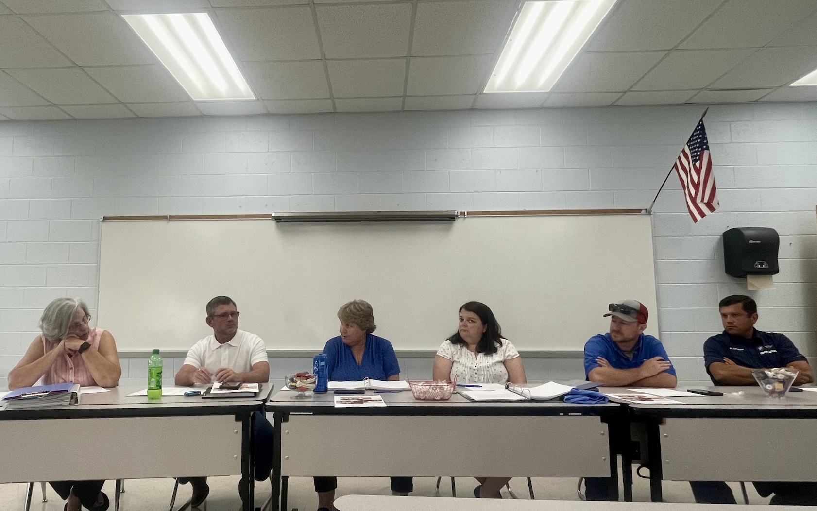 Members of the Board of Education (from left) Susan Robinson, Tim Poole, Superintendent Beverley Levine, BOE Chair Becky Soto, Jake Willcox and Guillermo Camacho discuss matters at the BOE meeting on Tuesday night. (JULIANNE AKERS/THE OGLETHORPE ECHO)