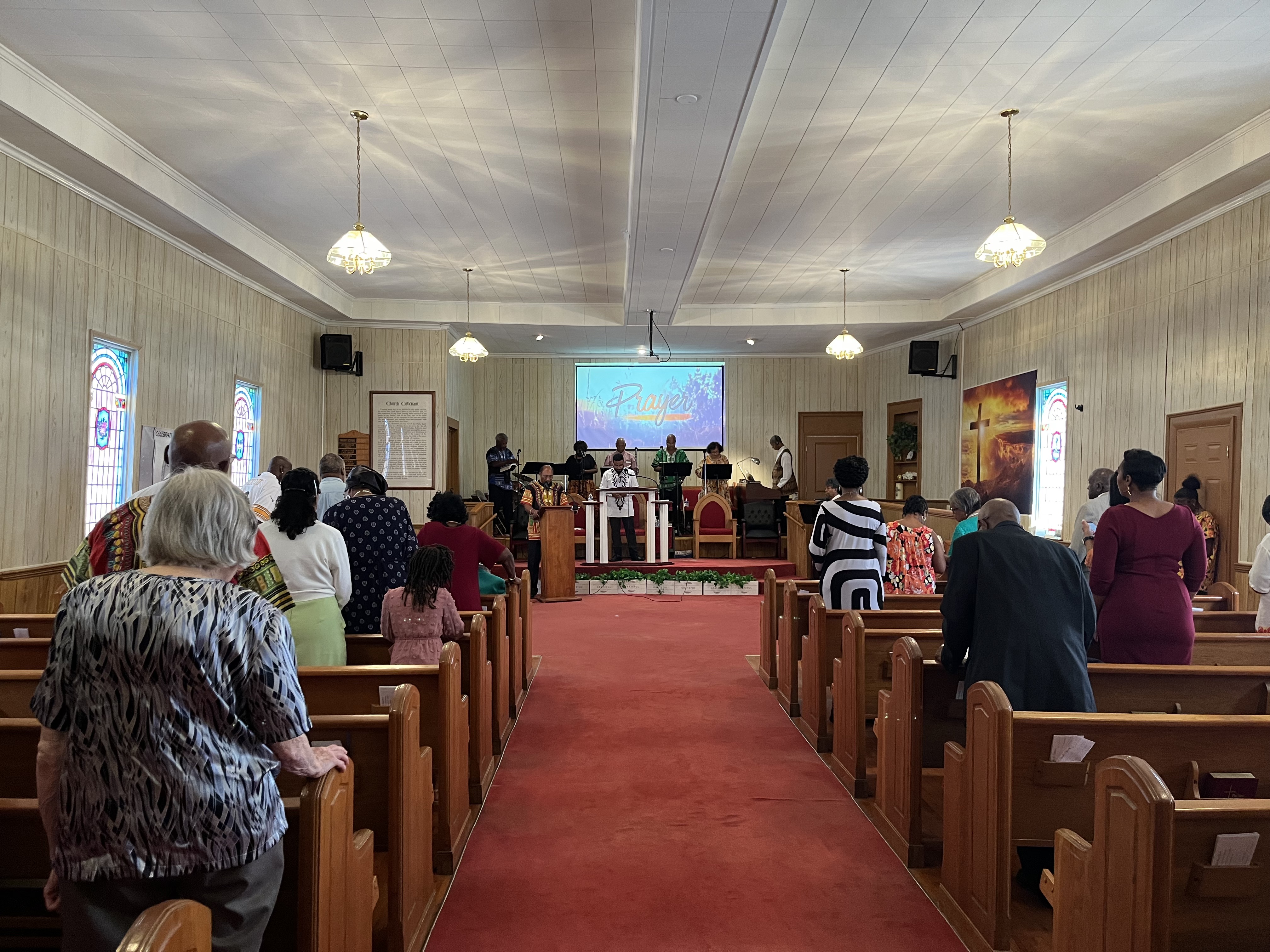 Members of the Piney Grove Baptist Church pray during homecoming service on the 151st anniversary on Aug. 20. (Meadow Barrow/The Oglethorpe Echo)