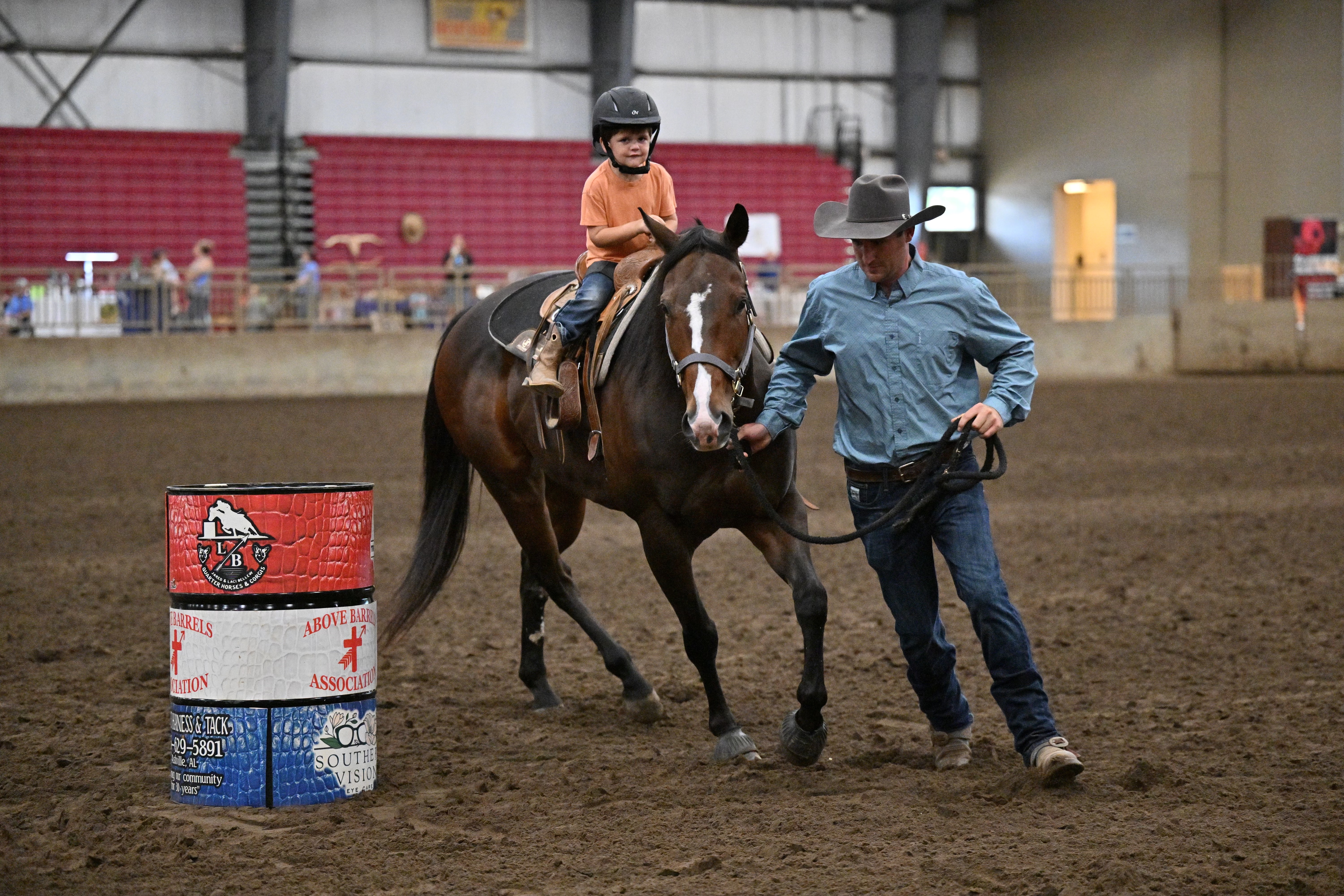 Chandler Bugg guides his son Walker Bugg while riding a horse during a “pee wee class” in Rainesville, Alabama.
