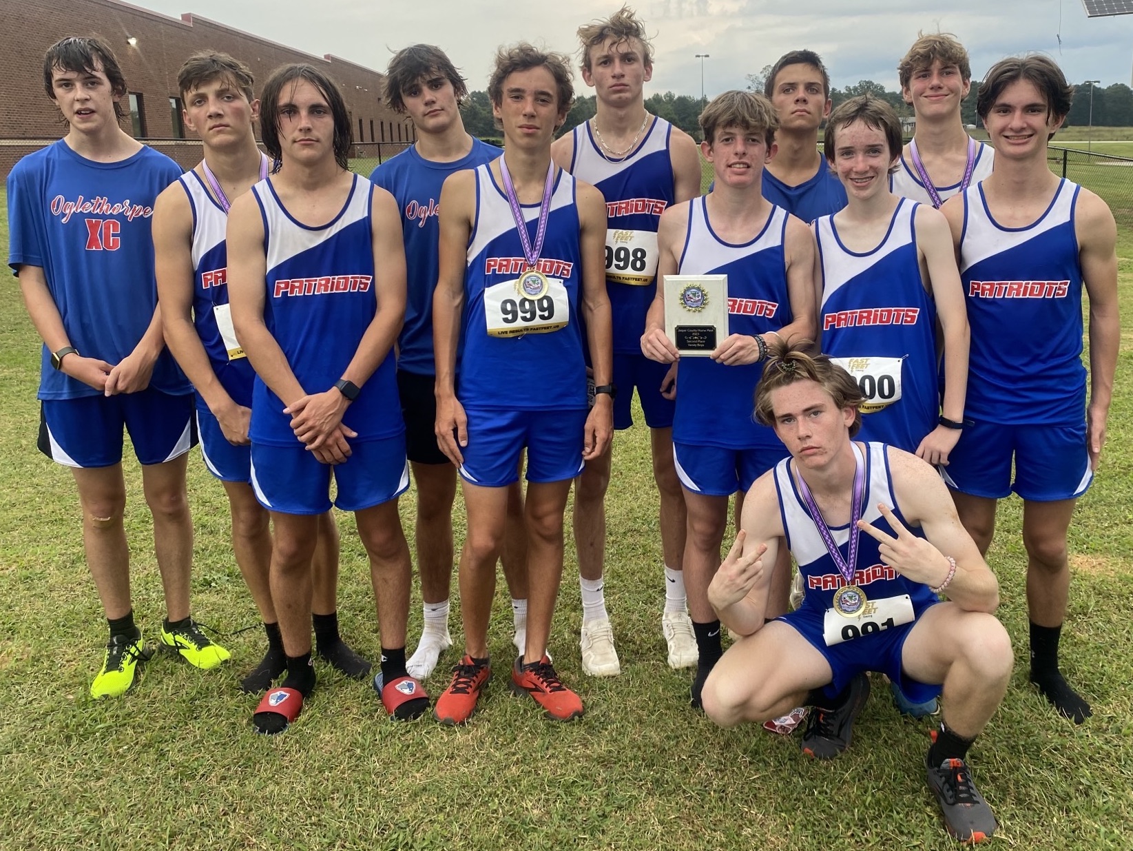 The OCHS boys cross country team consists of Nathen Reesman (from left), Landon Mallonee, Dominic Piscitelli, Ethan Dodd, Cory Tillman, Logan Tatum, Peyton Duvall, Phil Paradise, Josiah Young, Ethan McLean and Luke Holbrooks, and Logan Grier (front).