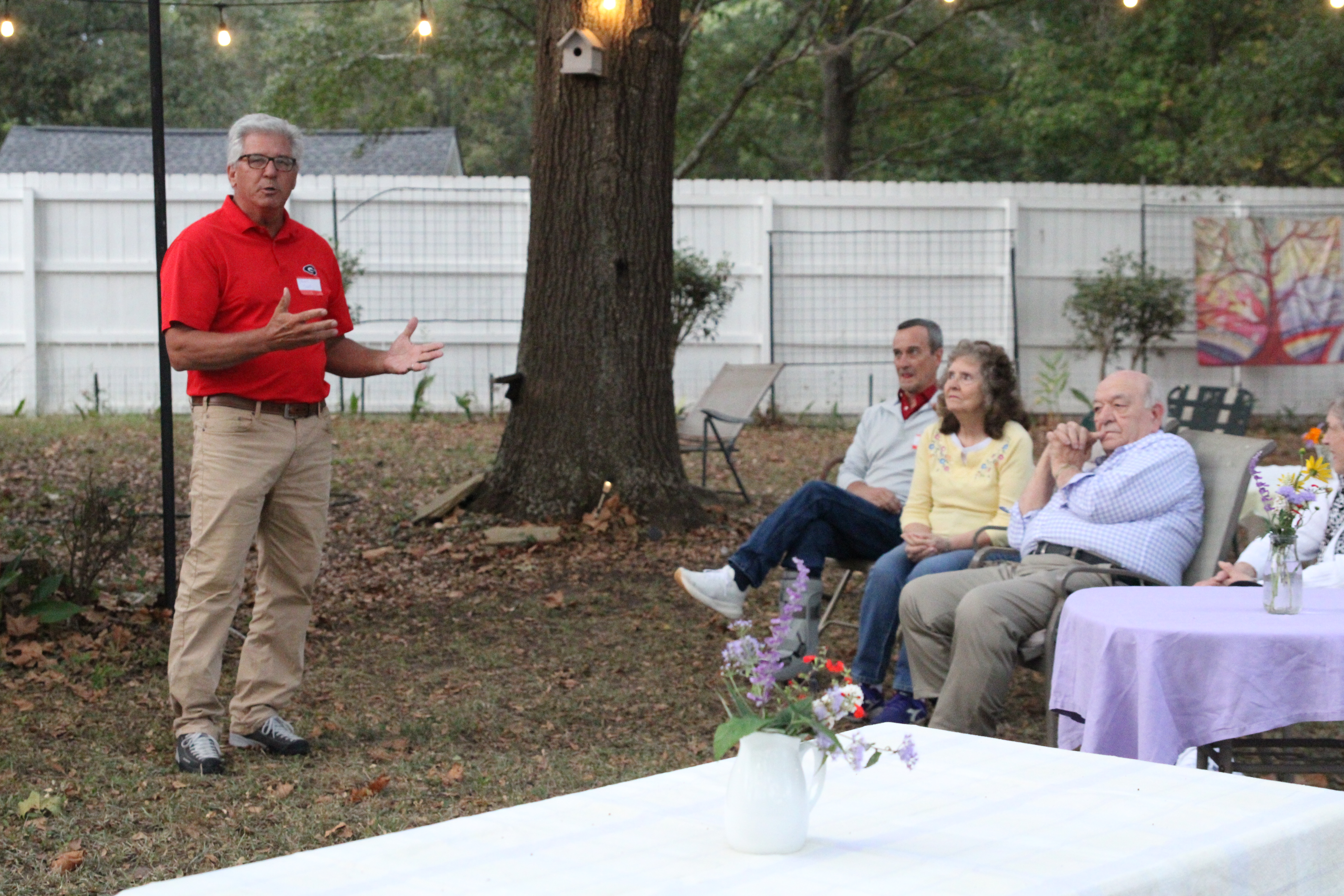 Arnoldsville City Councilman Danny Sniff (left) gestures toward Mayor Pro Tem Danny Morcom (far right) at the Arnoldsville meet and greet last Friday at No. 3 Railroad Street. Both men are running for mayor, but have shown respect and goodwill toward each other. “Am I endorsing Danny?” Sniff said. “To some degree, yes.” (photo/ Elena Acosta)