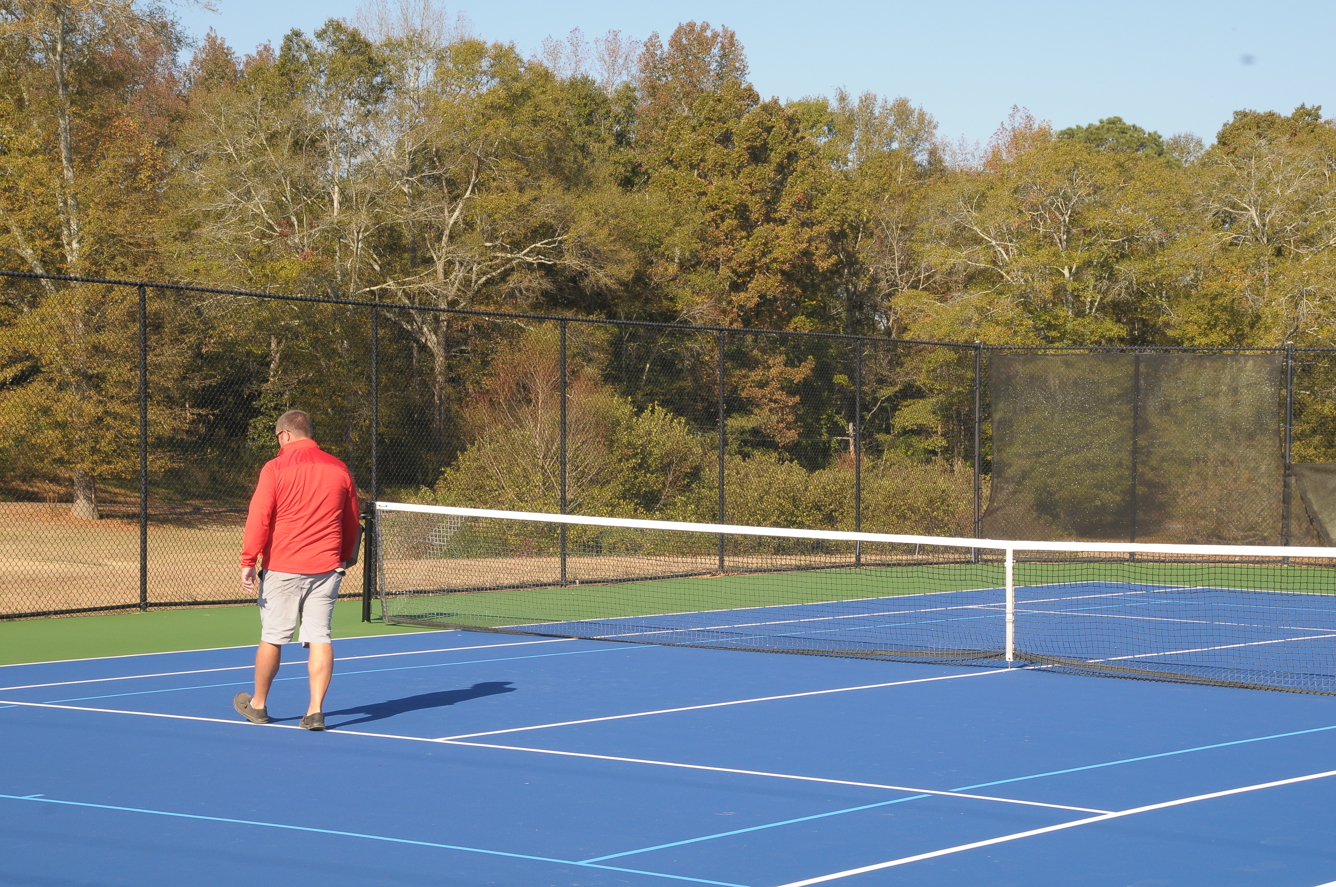 Oglethorpe County Recreation Department Director Mike White looks over the freshly resurfaced tennis courts. The repairs cost about $10,000, some of which was covered by original funding for the courts. (Christian Kirby II/The Oglethorpe Echo)