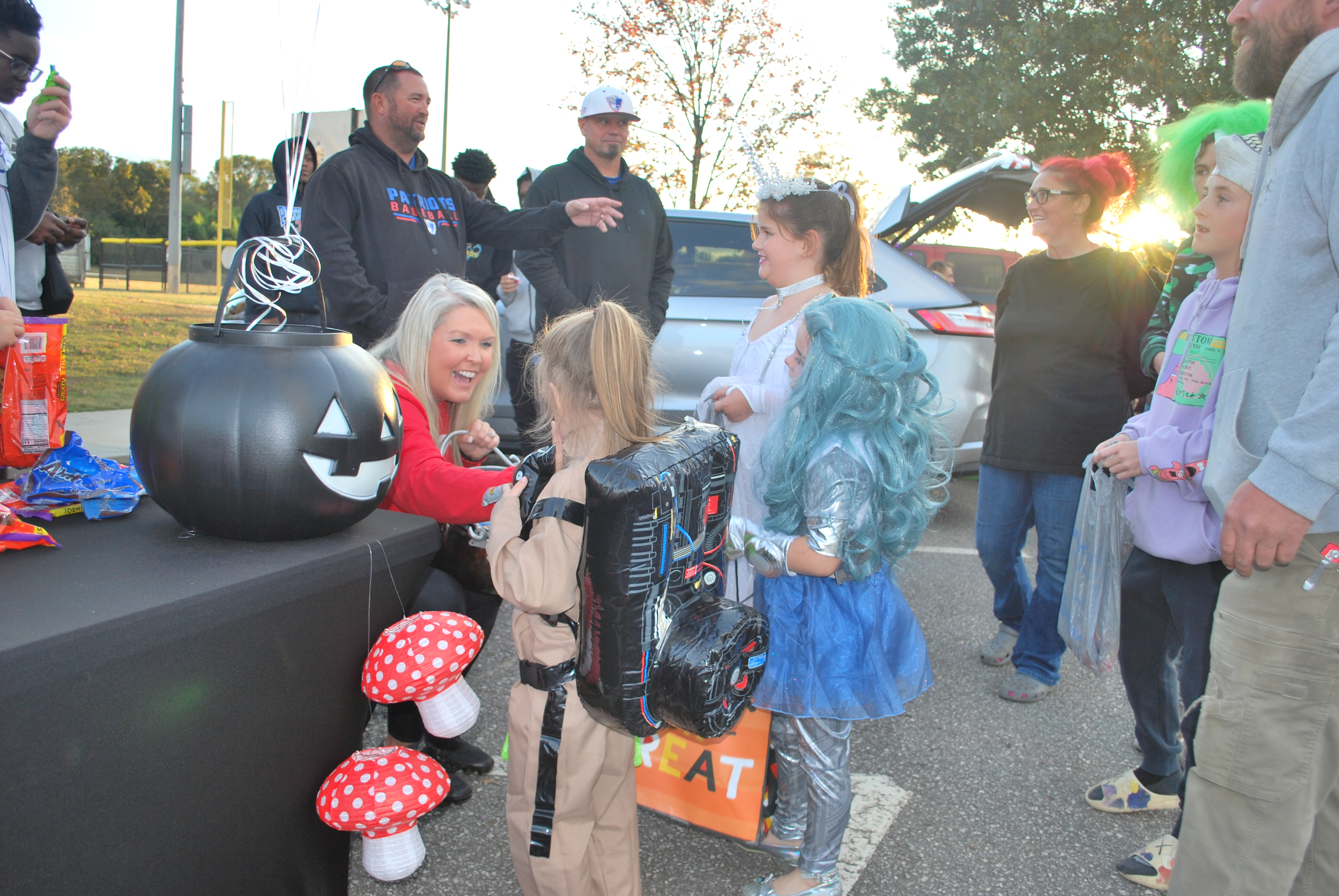 Tina White, the founder and organizer of Oglethorpe County’s Trunk or Treat event, distributes candy to siblings Zayne Kitchens (5), Zackari Kitchens (6) and Zailie Kitchens (9). This is White’s seventh year putting on the event and all of the work White puts into the event is completely volunteer based.