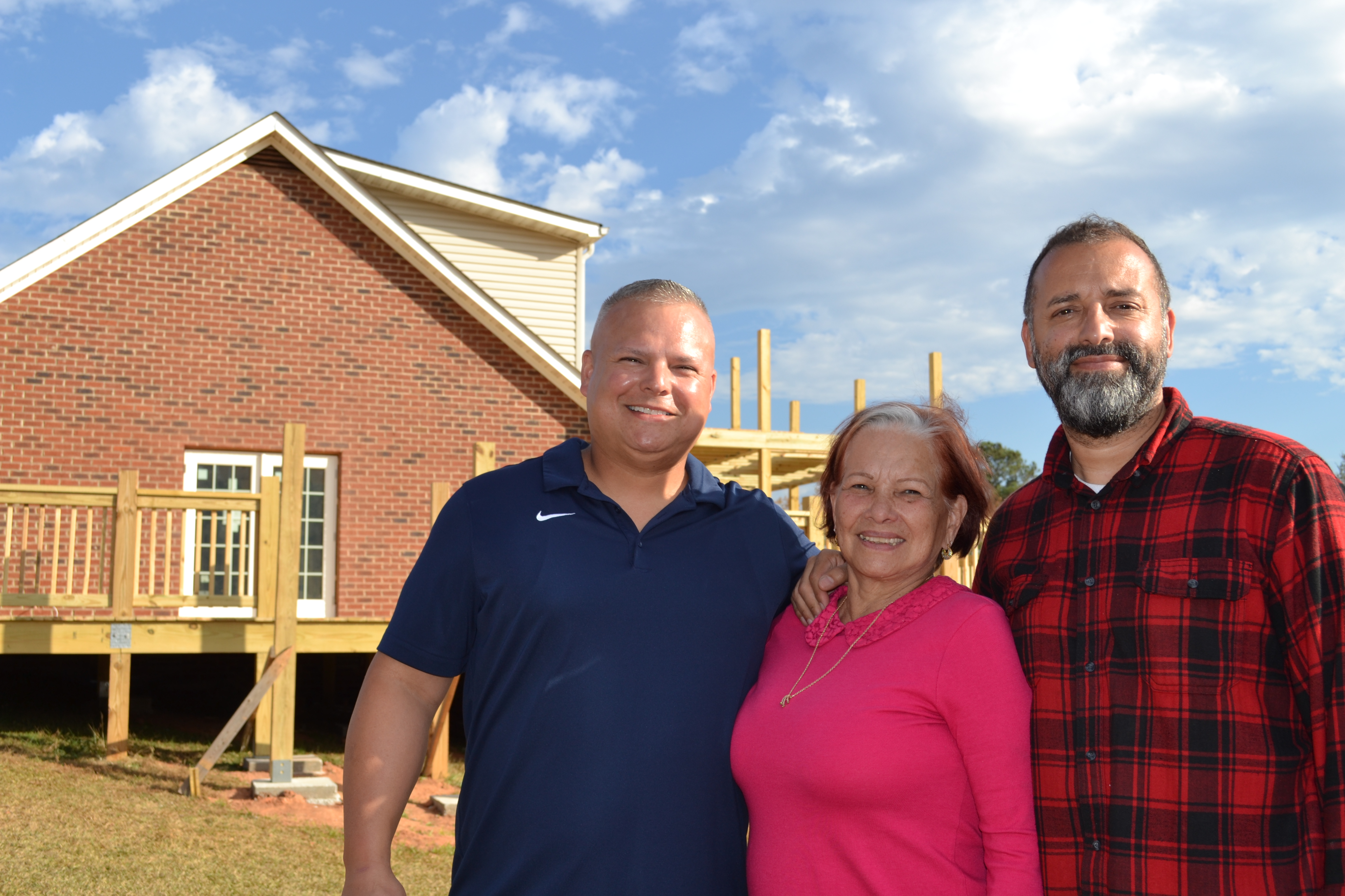 Josh Robayo (from left), Amy Delfin-Torres and Willie Torres stand in front of Town and Country Kafe, which will serve coffee and Spanish-inspired cuisine. The family plans to hold a grand opening early next month. (Grace Mains/The Oglethorpe Echo)