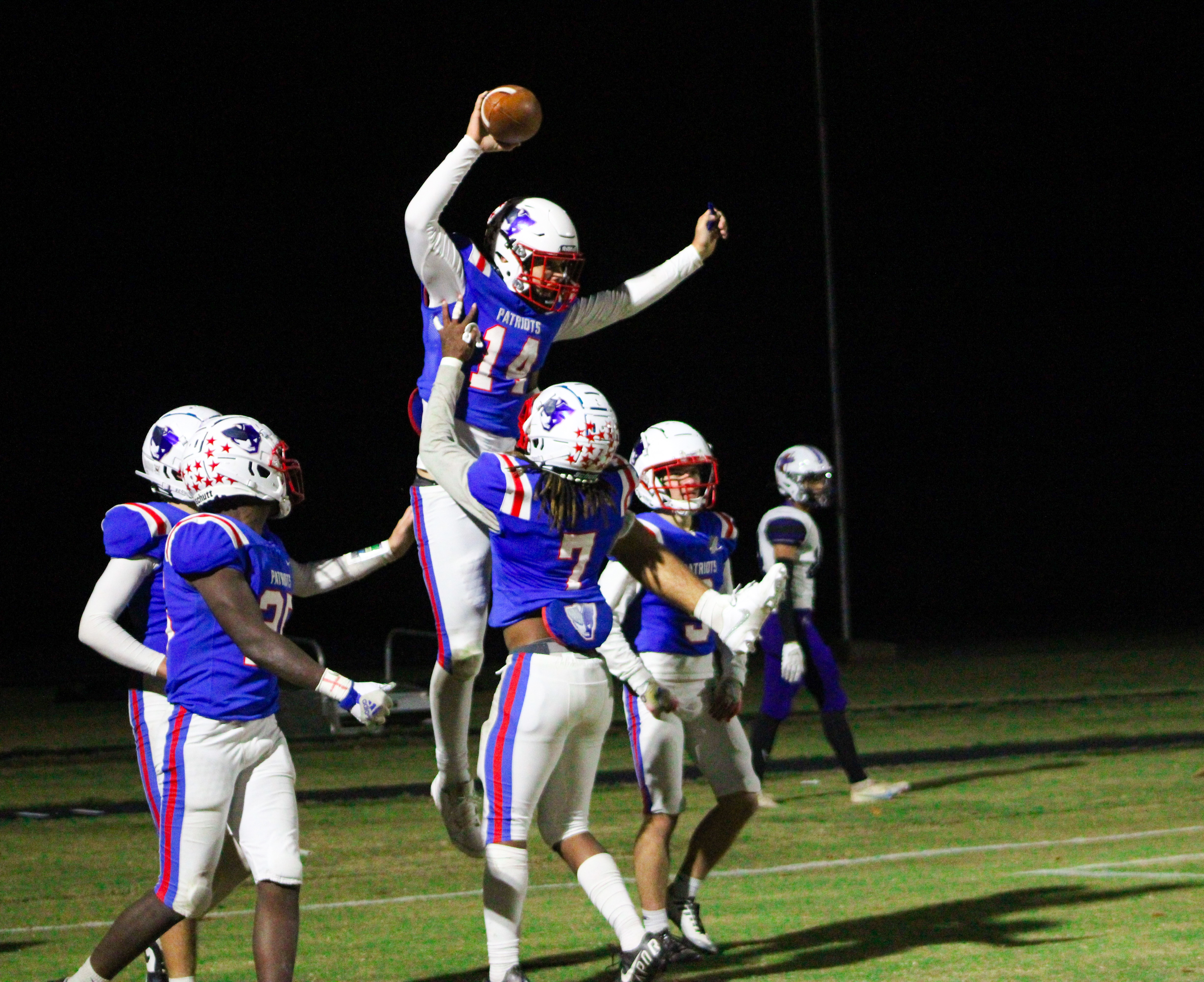 Ashton Sexton (14) gets lifted into the air by Keymon Pass (7) after scoring the game-winning touchdown to defeat Jasper County 35-28. Both players were honored before the game during the senior night ceremony. (Lauren Hill/The Oglethorpe Echo)