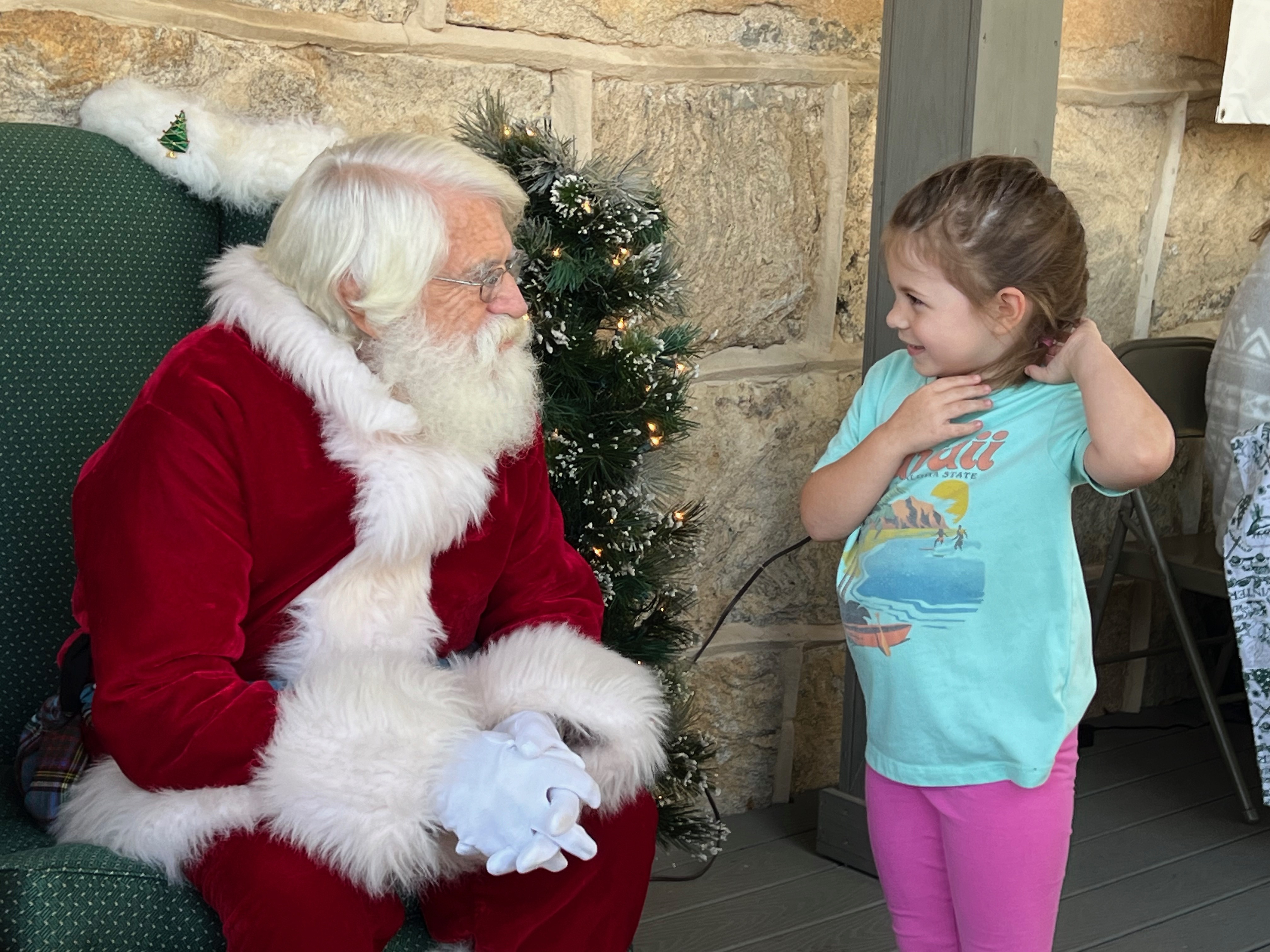 Santa listens as a child tells him what she wants for Christmas at the annual Christmas Marketplace in Crawford last weekend. Santa (Jim Anderson) travels to Oglethorpe County to appear as Santa Claus during the holiday season. Jordan Long/The Oglethorpe Echo 