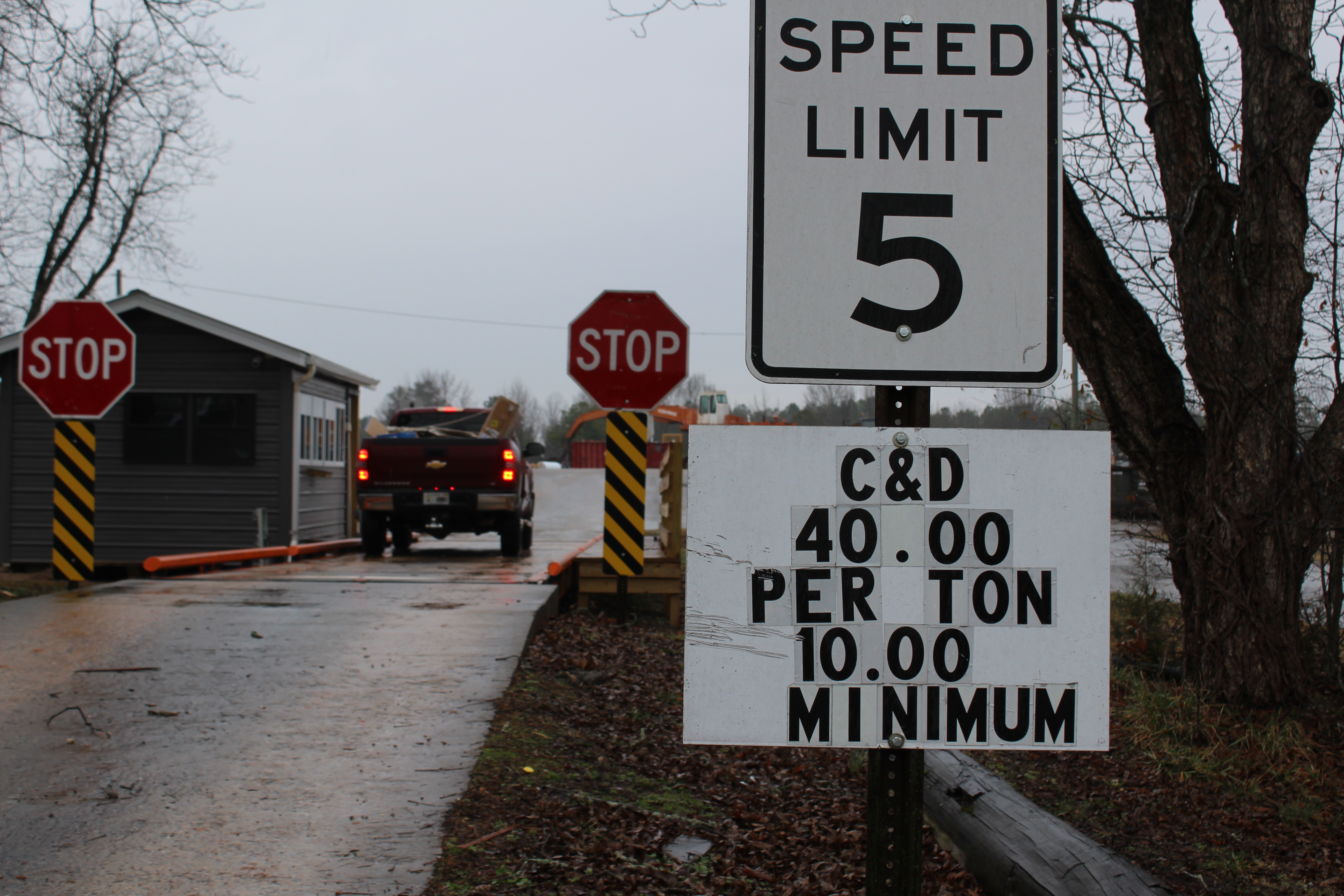 A truck pulls into the Oglethorpe County Construction and Demolition Landfill, passing a sign indicating the tipping rates for disposal. The rates underscore measures being taken to ensure long-term waste capacity.  (Abby Peacock/The Oglethorpe Echo)