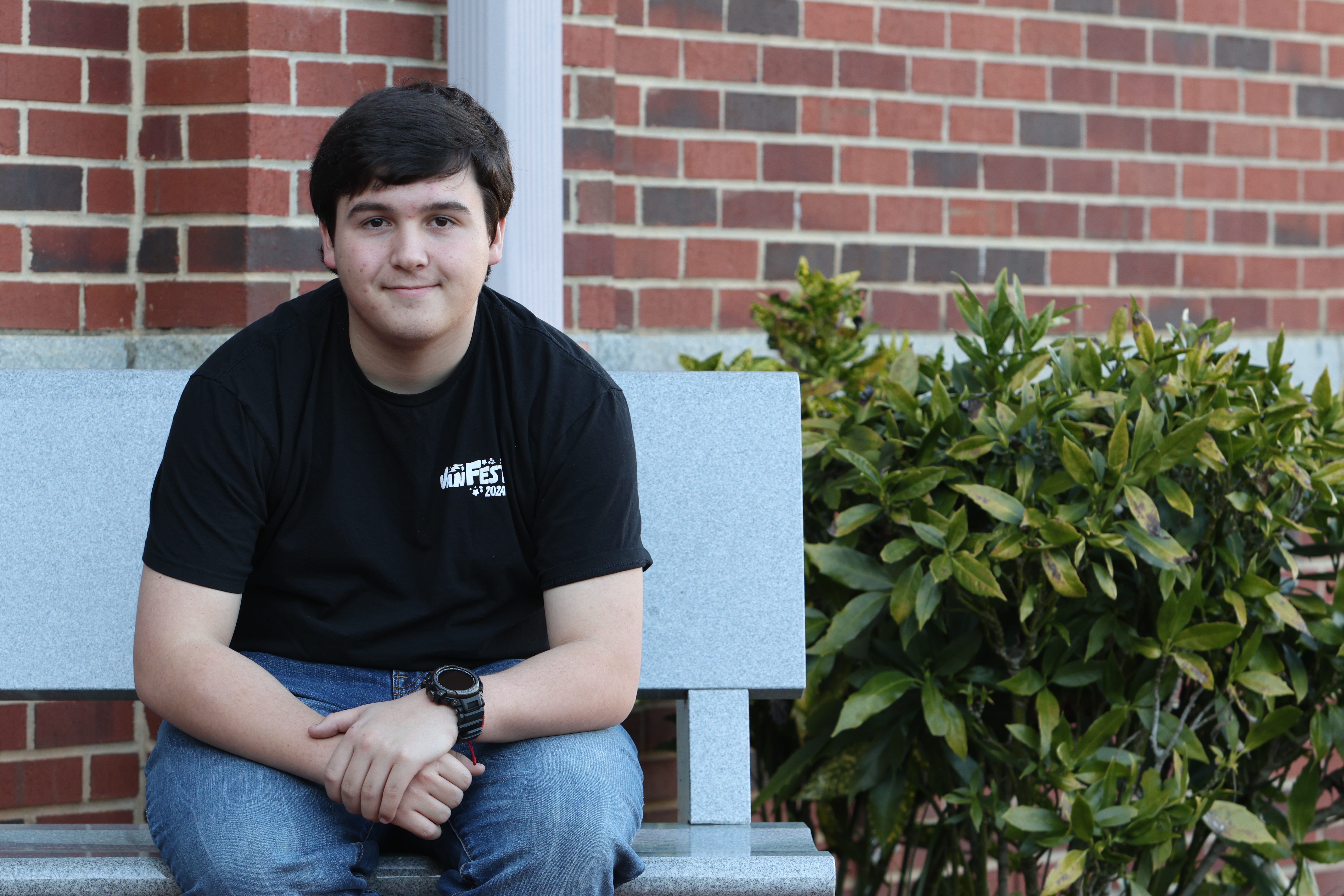 Nathan Wilson poses on a bench outside of Oglethorpe County High School on Jan. 31, 2024. Nathan Wilson was chosen as a finalist for the 2024 Questbridge scholarship. (Photo/Jim Bass)