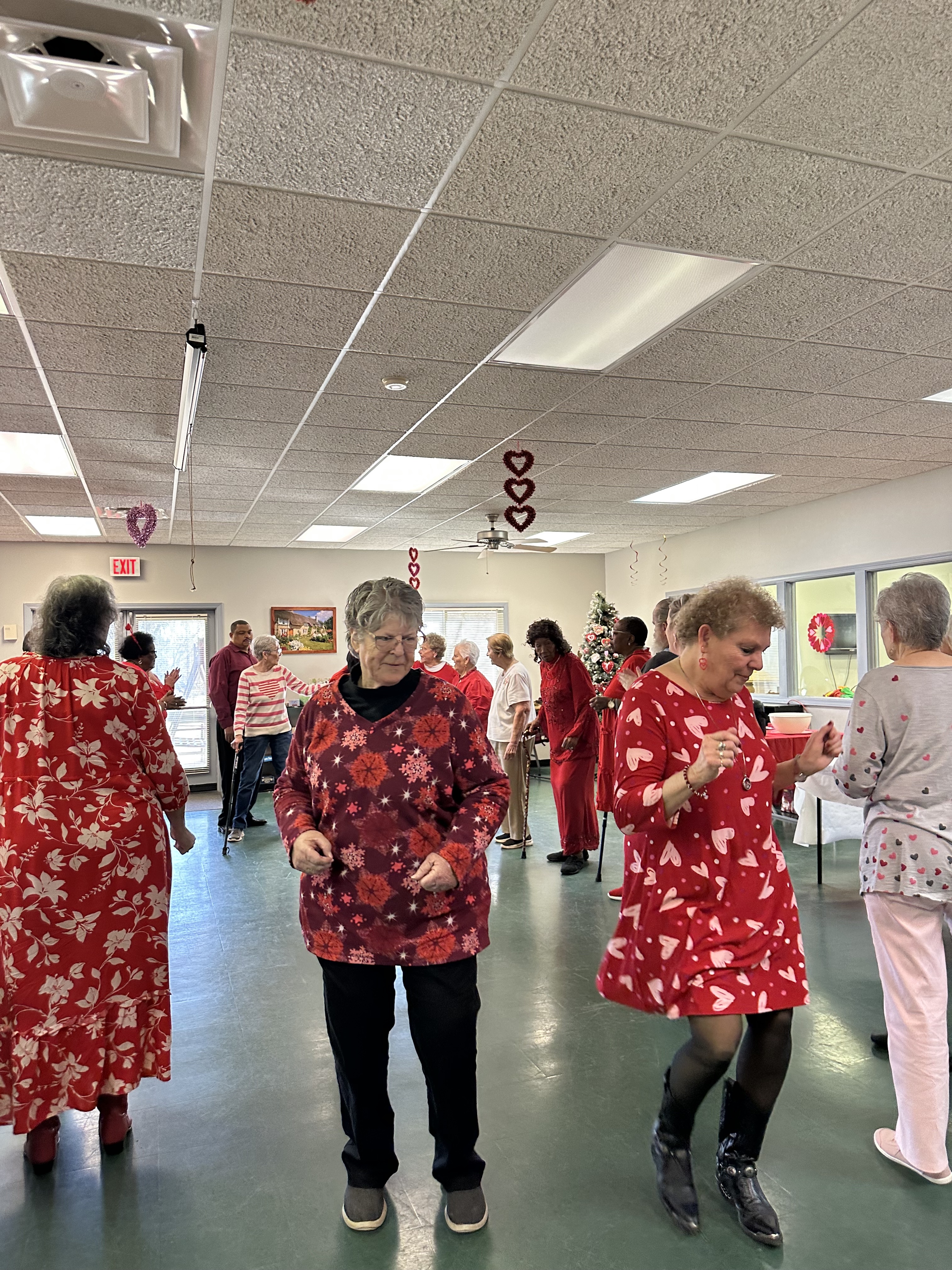 Debbie Winsett (right) and Rosanne Iturrian (left) make their way down the soul train line in a dance to Love Train by The O'Jays. This dance was a crowd favorite during the Valentine's Day event. (Lily Murphy/Oglethorpe Echo).