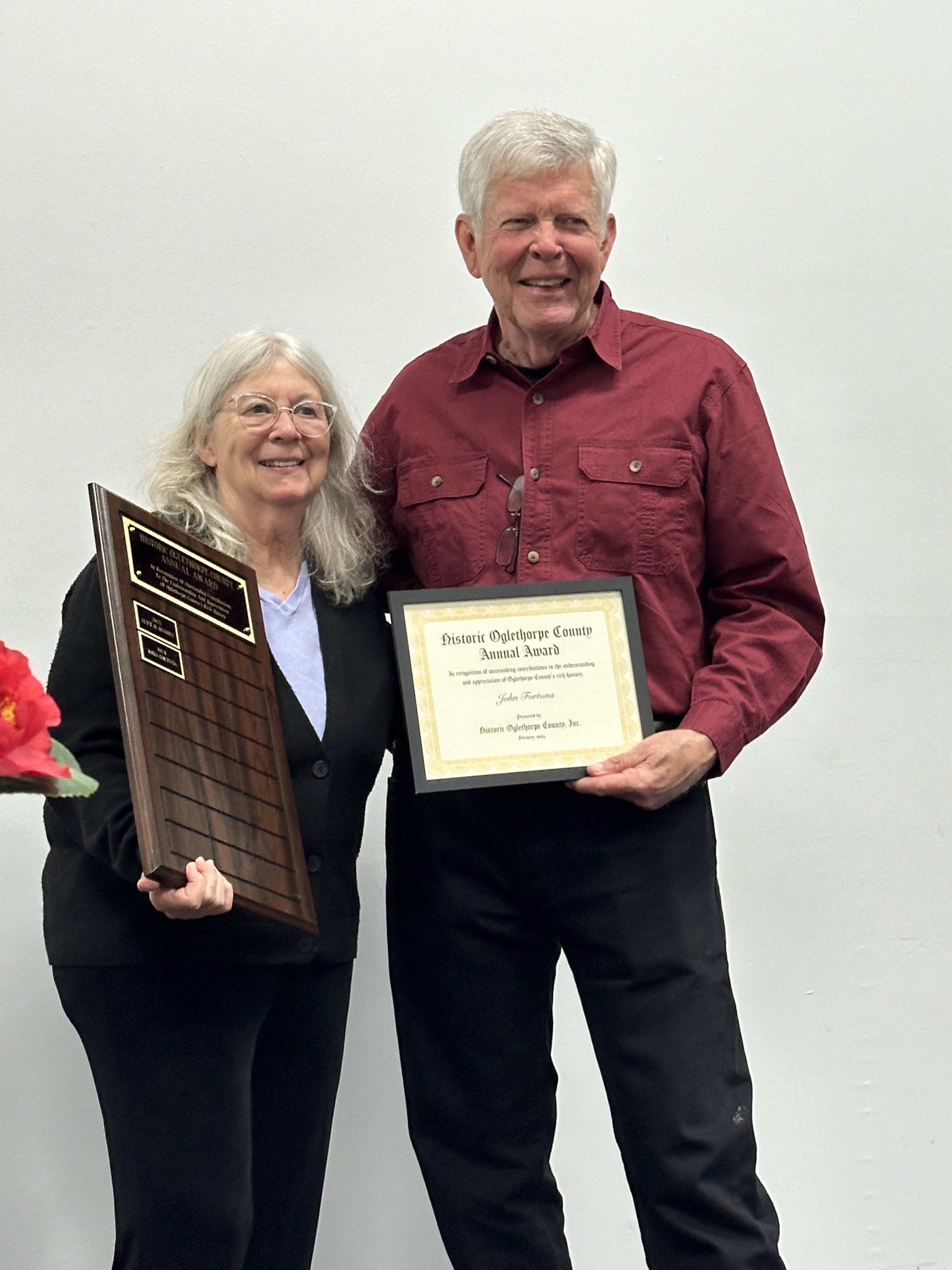 John Fortuna receives a certificate from Kathleen deMarrais, presi- dent of Historic Oglethorpe County after receiving the annual  Historic Oglethorpe County Annual Award at the organization’s banquet on March 1. (Photo/Izzy Wagner)