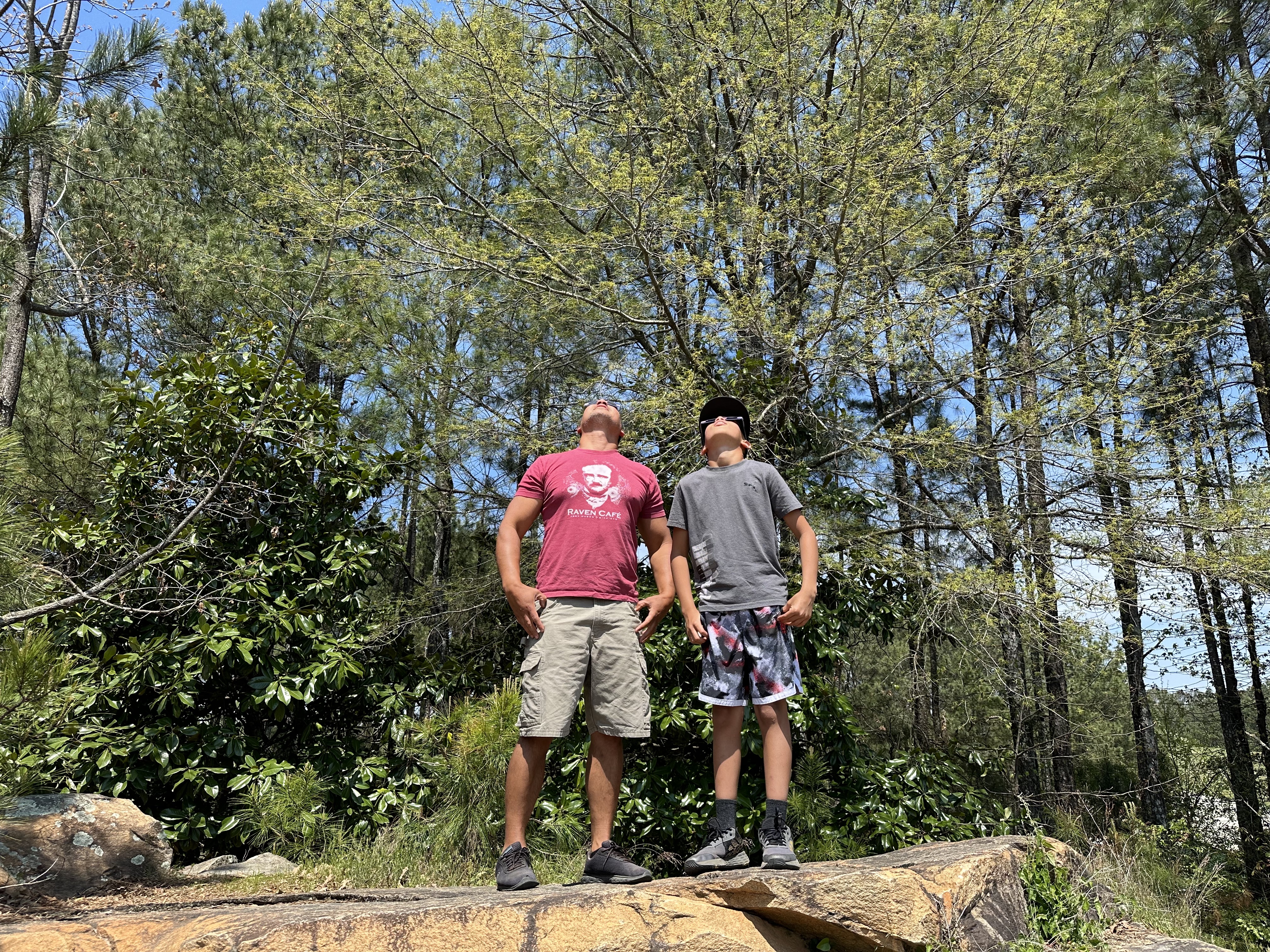 Anthony Tambling (left) and his son Graysen Tambling attended the viewing event at the Oglethorpe County Library. The two stood on a nearby boulder to get a clear view of the sun. (Photo/Izzy Wagner) 