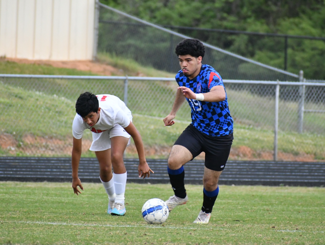 Bryan Berrios (19) moves past a Rabun County defender in the  first round of the Class A Division I tournament last week. The loss  ended the Patriots’ season. (Wade Cheek/For The Oglethorpe Echo)