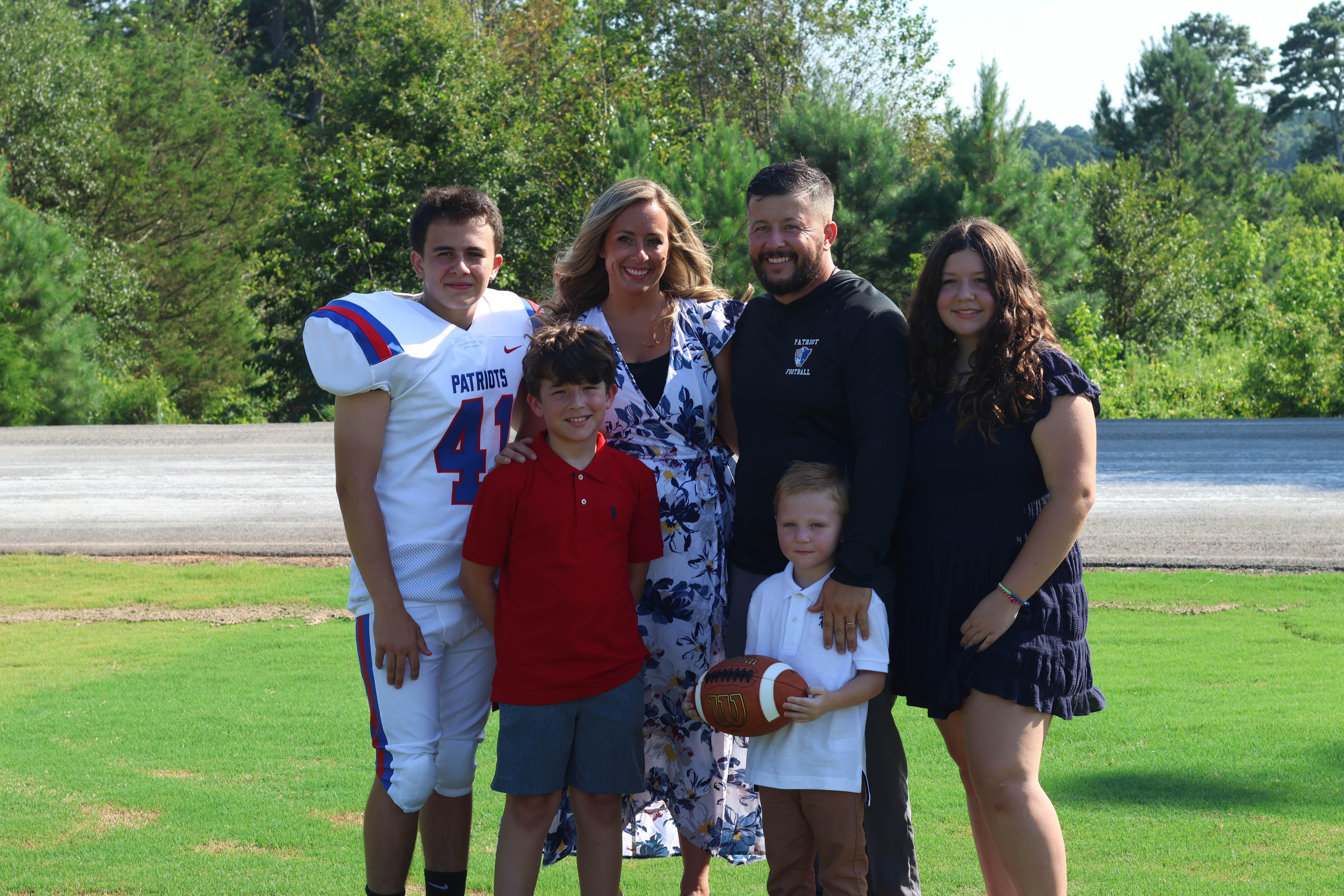 OCHS head coach Mike Holland and his family pose for football picture day at the OCHS football field on Monday, July 31, 2023. Holland is joined by his son Kingston Holland, who played football for the first time in 2023. (Landen Todd/The Oglethorpe Echo)