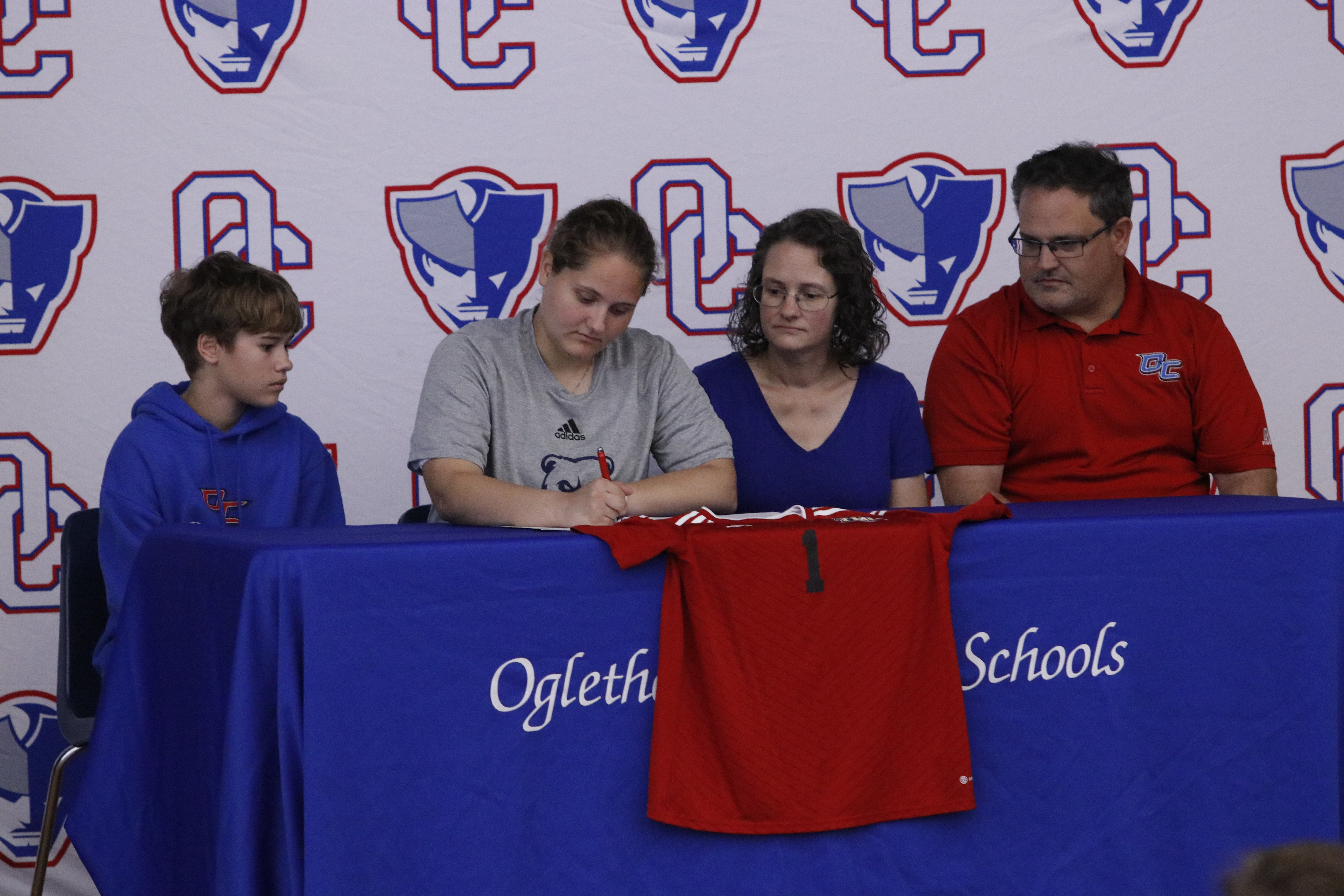 Anna Adams signs her letter of intent to play soccer at Truett McConnell next year as brother John, and parents Mandy and Brandon Adams, look on at OCHS last week. Anna plays goalkeeper for the soccer team. (Torin Smith/The Oglethorpe Echo)