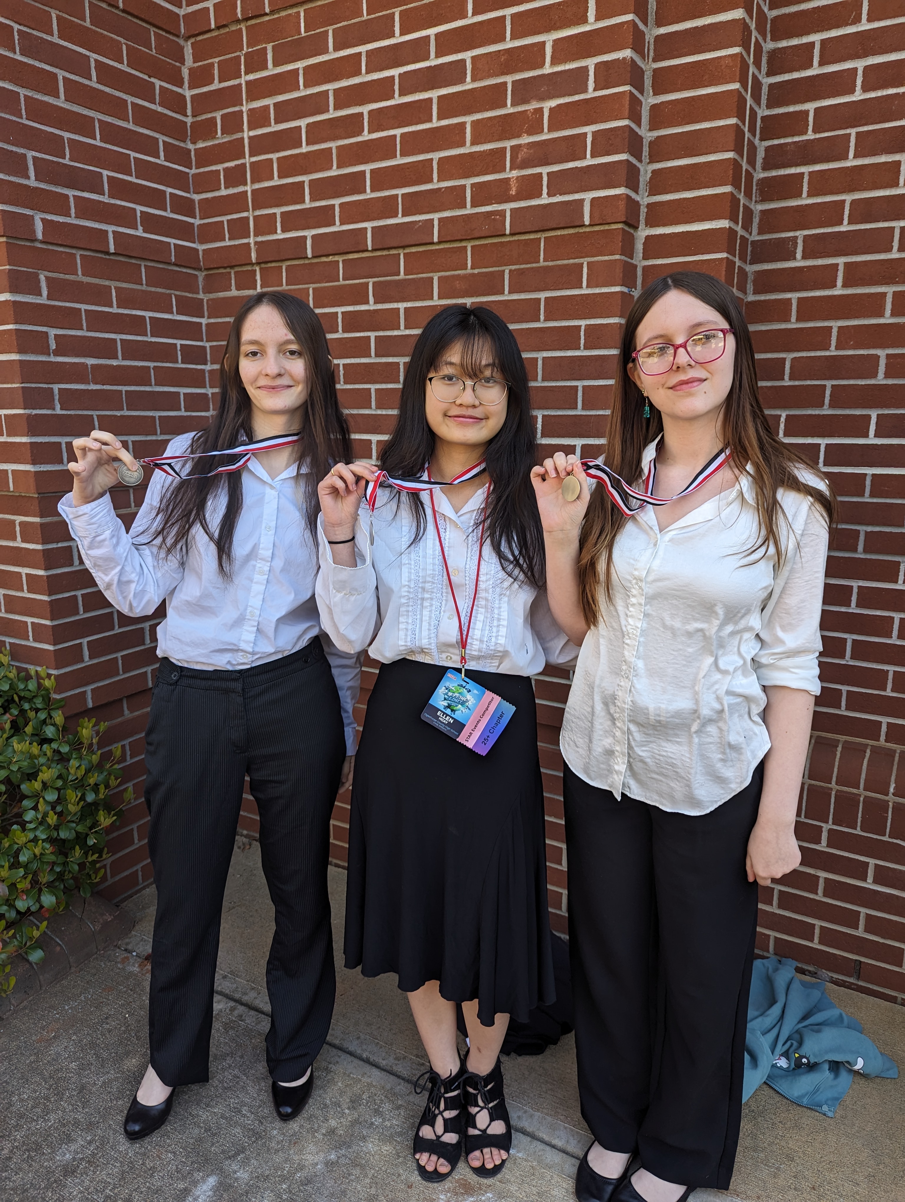 Grace Foland (from left), Ellen Hgay and Miley Christian show their silver medals after finishing in second in the Fashion Design category with their project called Fashion Forward. All three are sophomores at OCHS. (Submitted Photo)