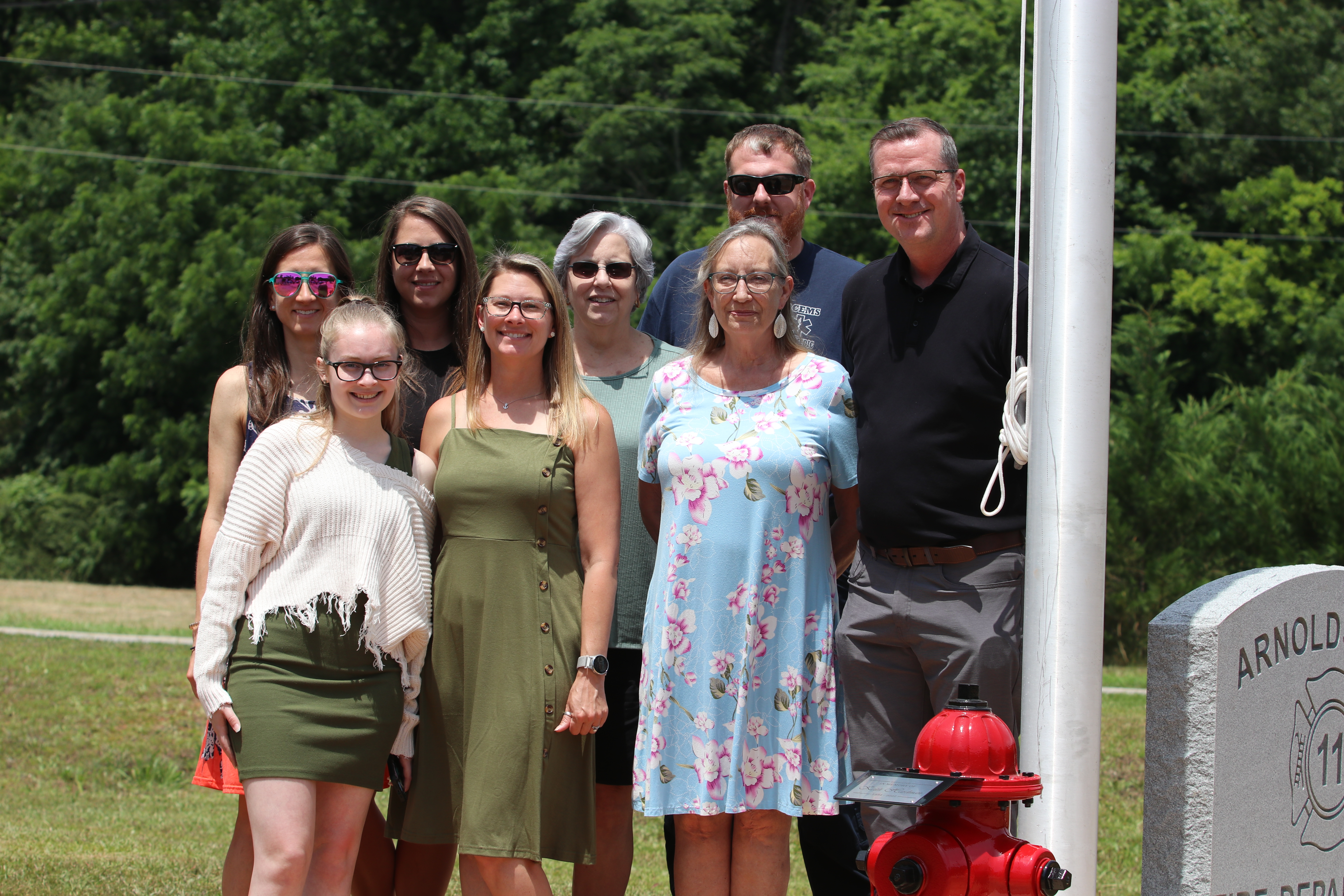 Keith Hardman’s family attended the ceremony in which the flagpole at the Arnoldsville Volunteer Fire Department was dedicated to the former firefighter. Family members include (back row, from left) niece Ashley Escoe, niece Erin Bunch, sister Susan Robinson and nephew Josh Robinson; (front row, from left) granddaughter Caitlyn Ponder, daughter Brittany Ponder, wife Colleen and son-in-law Brian Ponder. (Torin Smith/The Oglethorpe Echo)