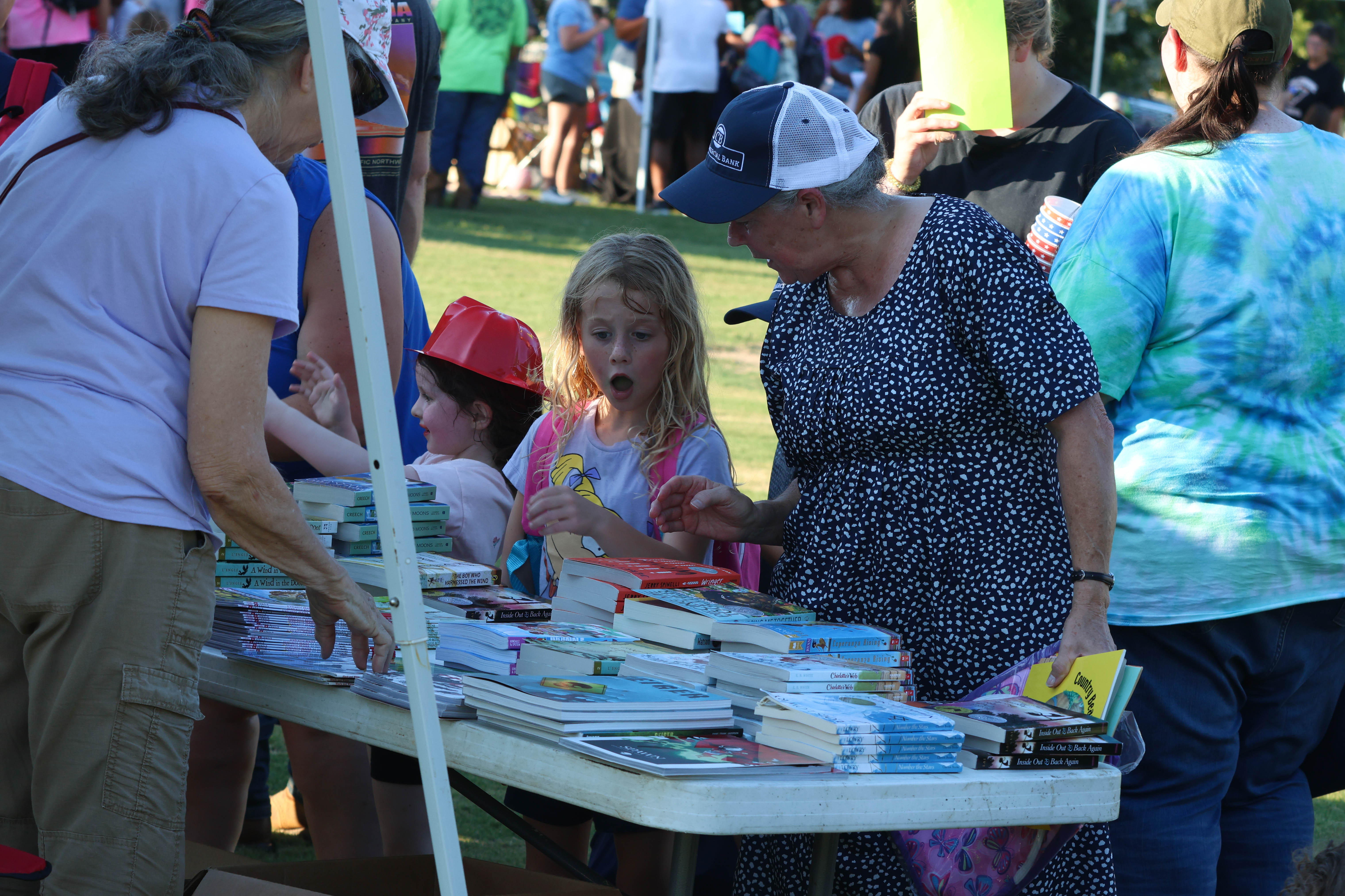 Braelee Roberts (left) and her grandmother Judy Hicks look for a new book during the annual Community Day at Bryan Park last August. The annual Community Day will start at 6:30 p.m. Saturday, Aug. 3. (Landen Todd/The Oglethorpe Echo)