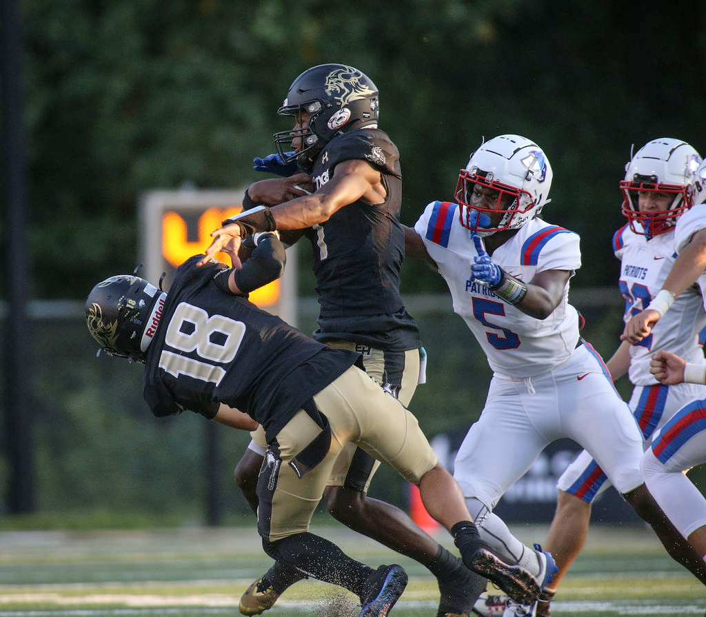 Oglethorpe County’s Justin Jackson (5) tries to stop East Hall quarterback Jamarcus Harrison (1) in the Vikings’ 40-7 win over the Patriots last Friday in Gainesville. Harrison threw for 202 yards and three touchdowns. (AMANDA LOGGINS/THE GAINESVILLE TIMES)