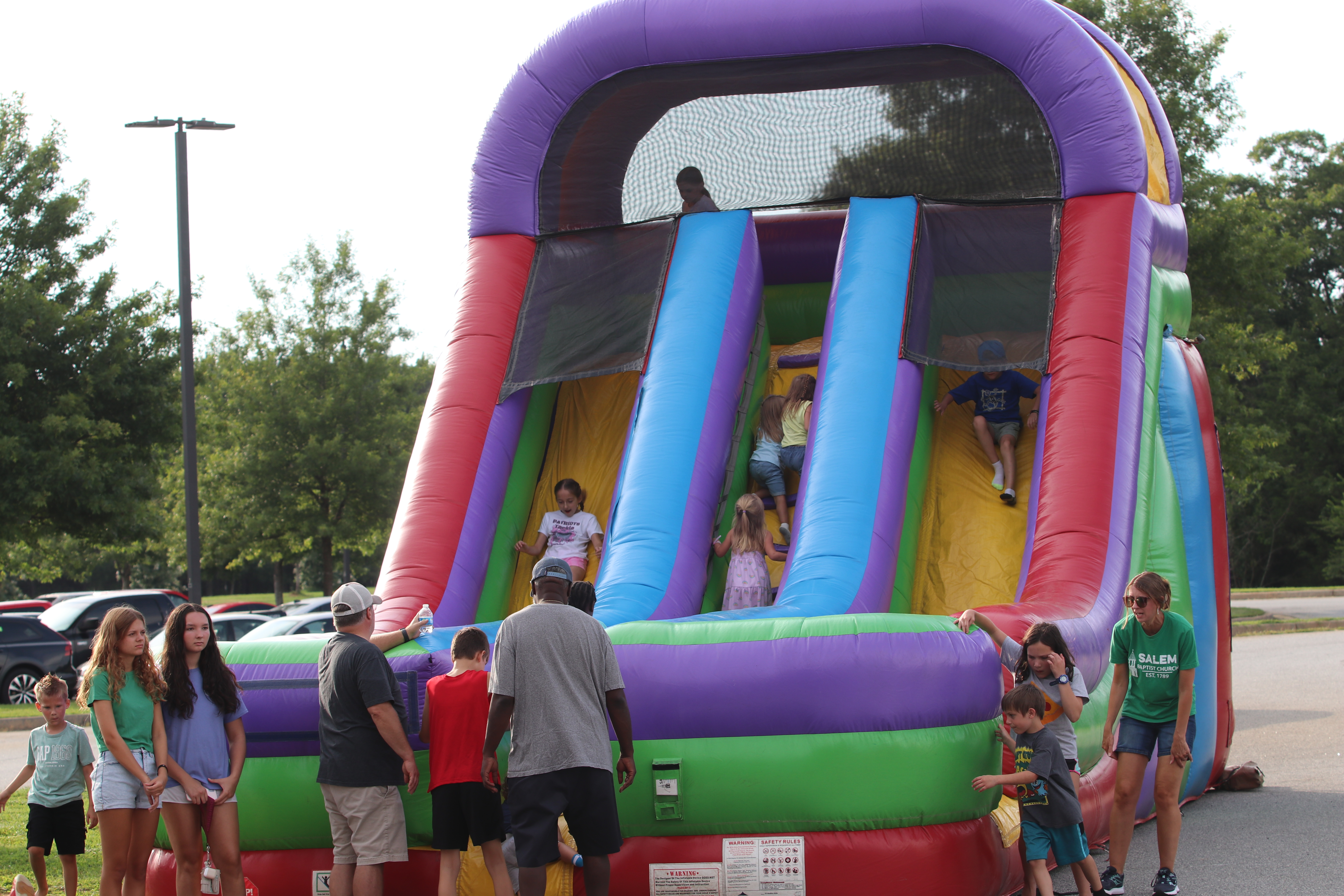 Children enjoy Salem Baptist Church’s bounce house slide, an annual favorite at Community Day. The event was moved to OCMS, which might become a permanent home. (Torin Smith/The Oglethorpe Echo)