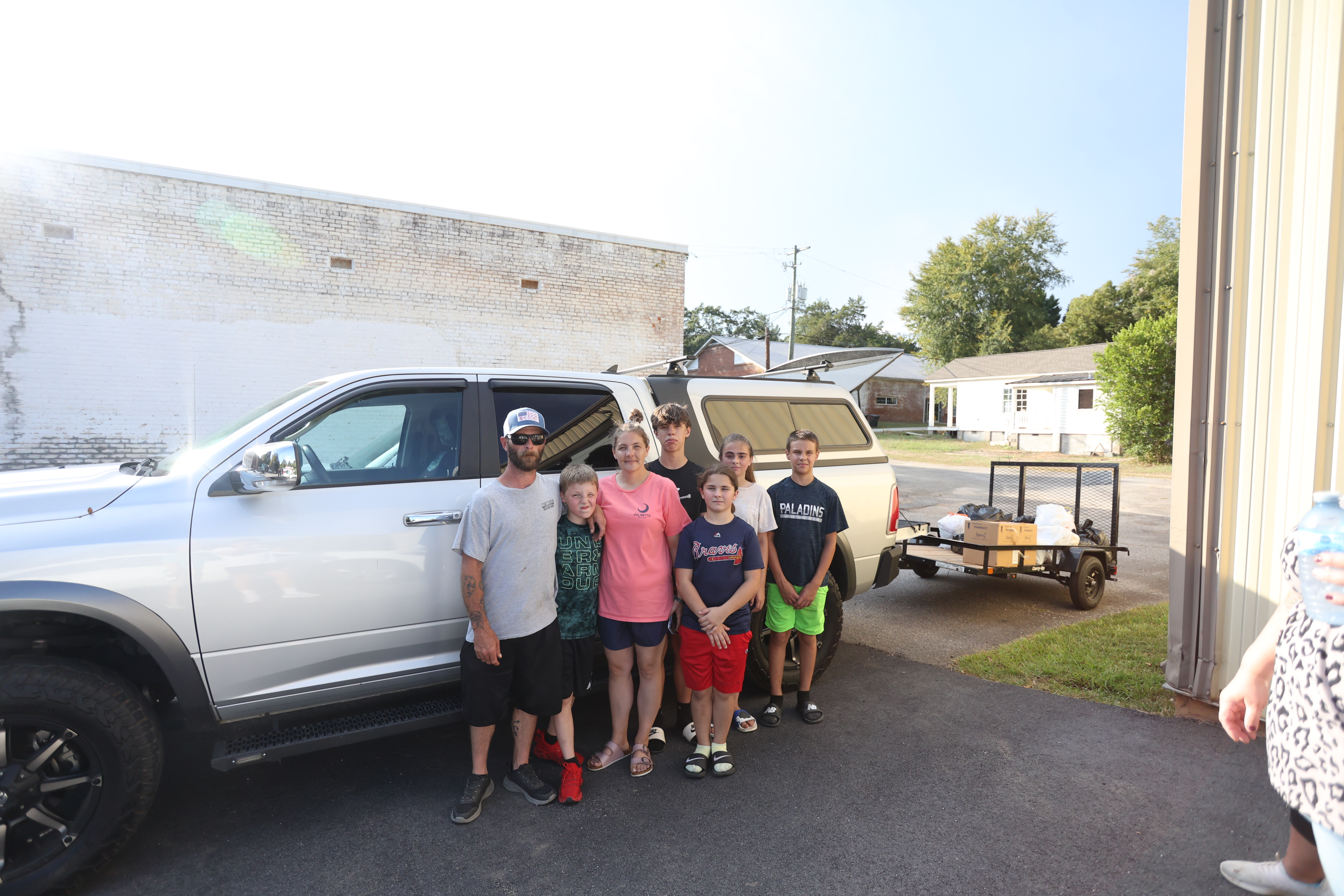 The Cronic family greeted visitors and helped unload donations at the Lexington Fire Department on Aug. 30. They include William Cronic (from left), Caden Roberts (10), Cody Cronic, Landon Roberts (15), Bridgette Cronic (11), Rebekah Heath (11) and Eli Roberts (12). An infant isn’t pictured. (TY JOHNSTON/THE OGLETHORPE ECHO)