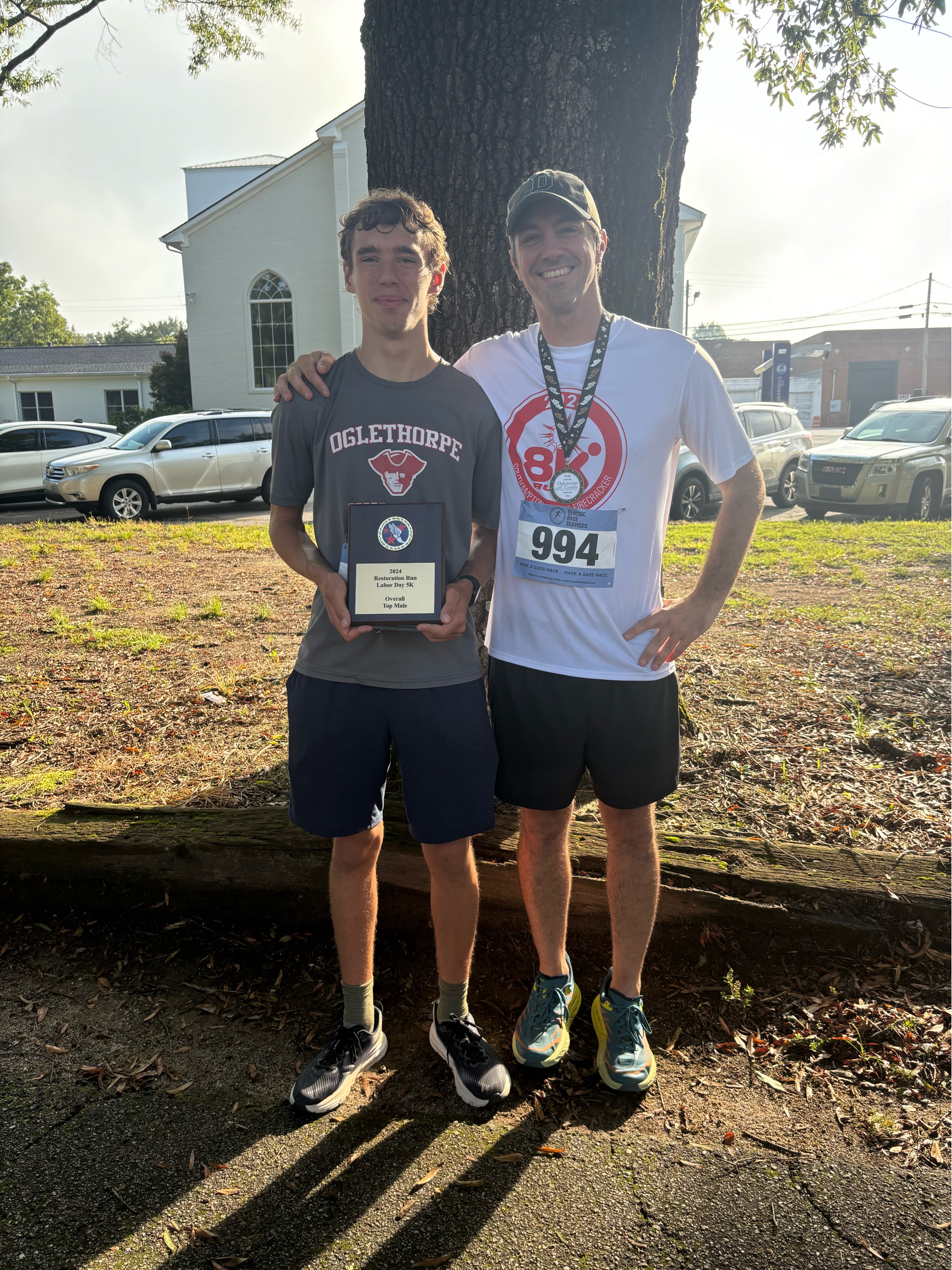 Cory Tillman and his father Glenn Tillman pose after finishing the 20th annual Restoration Labor Day 5K. Cory was first overall and Glenn finished sixth, first in his age group (40-49). (Submitted Photo)