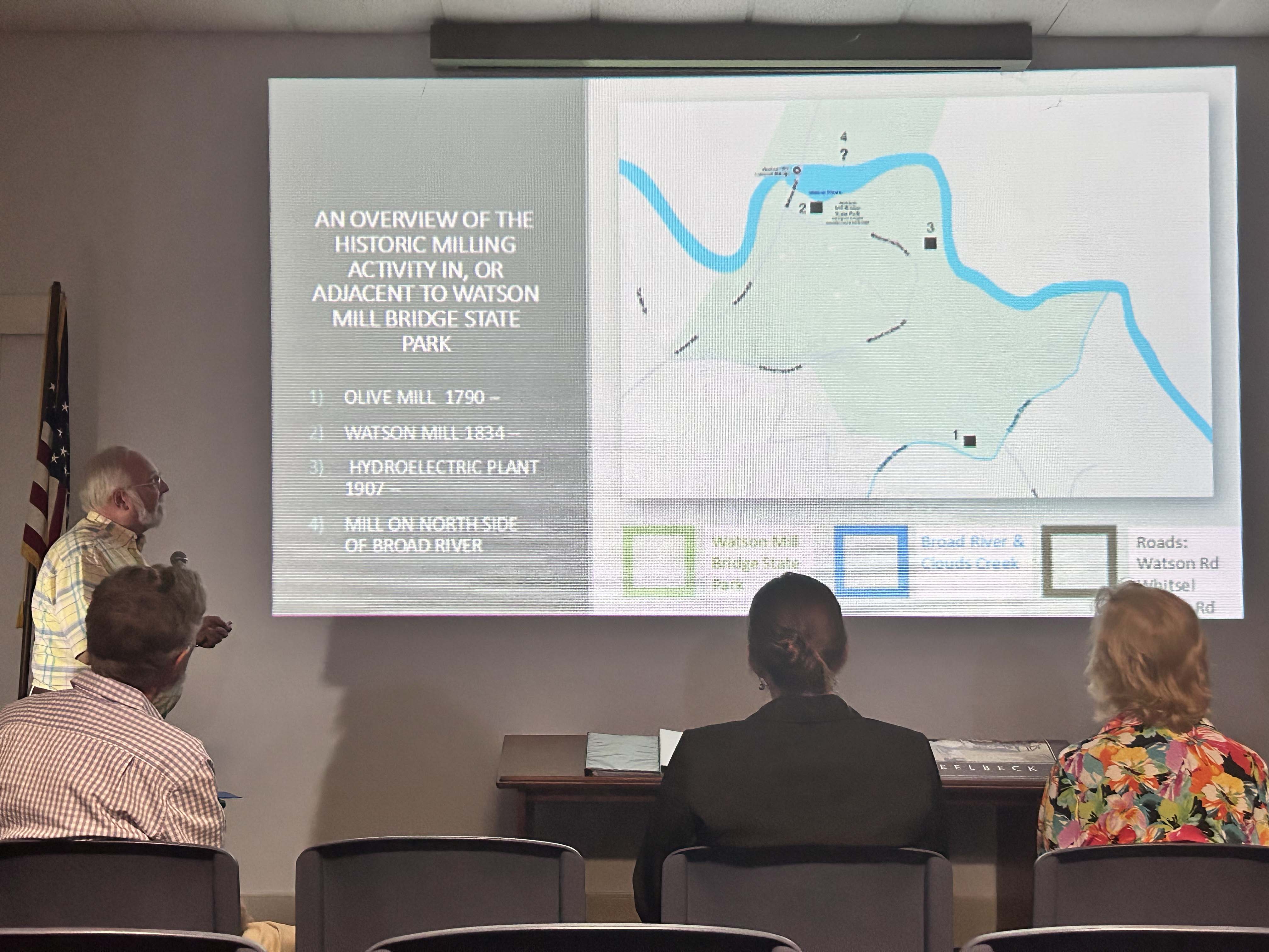 Greg Yoder reports on the discovery of 42 water mills around the county at the Historic Oglethorpe County's September meeting on Tuesday, Sept. 24, 2024. Yoder and Tom Gresham's research is part of the Atlas Project. The slide on screen shows a map of Watson Mill Bridge State Park. (McCain Bracewell/The Oglethorpe Echo)