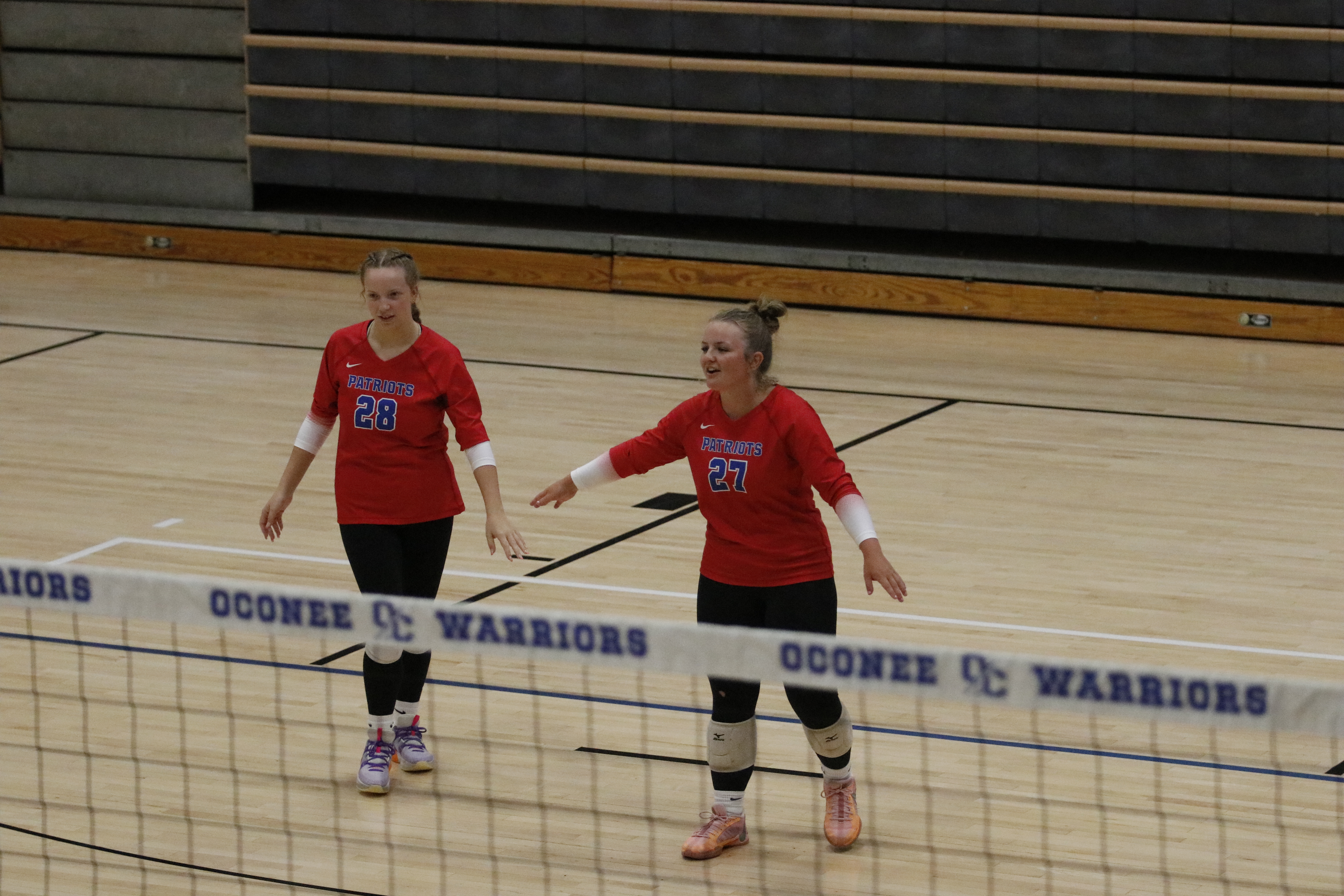 OCHS seniors Samantha Amos (left) and Sofia Horsley (right) encourage each other after the Patriots scored a point in a scrimmage against Rabun County this summer. OCHS seeks to win its second consecutive area championship this fall. (Torin Smith/The Oglethorpe Echo File)